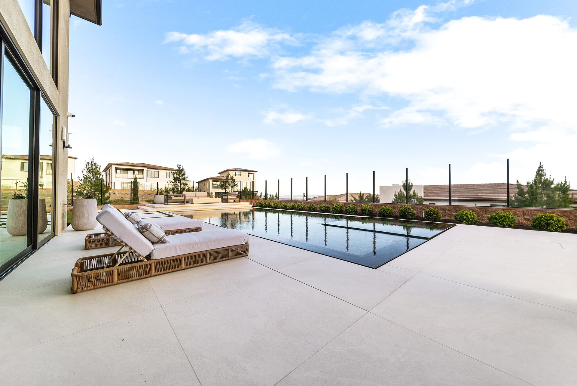 Luxury pool design and construction in Porter Ranch, Los Angeles. Design and build by Westmod. Day time photo of completed custom pool and outdoor living space.