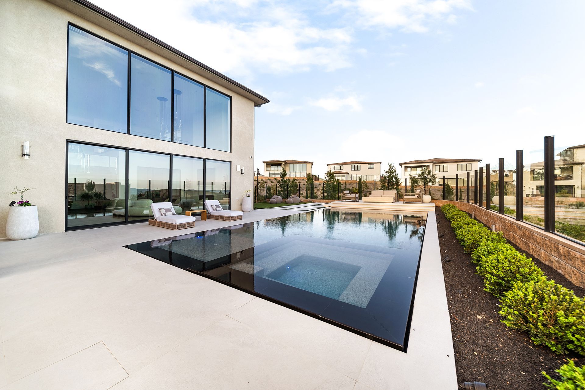 Luxury pool design and construction in Porter Ranch, Los Angeles. Design and build by Westmod. Day time photo of completed custom pool and outdoor living space.