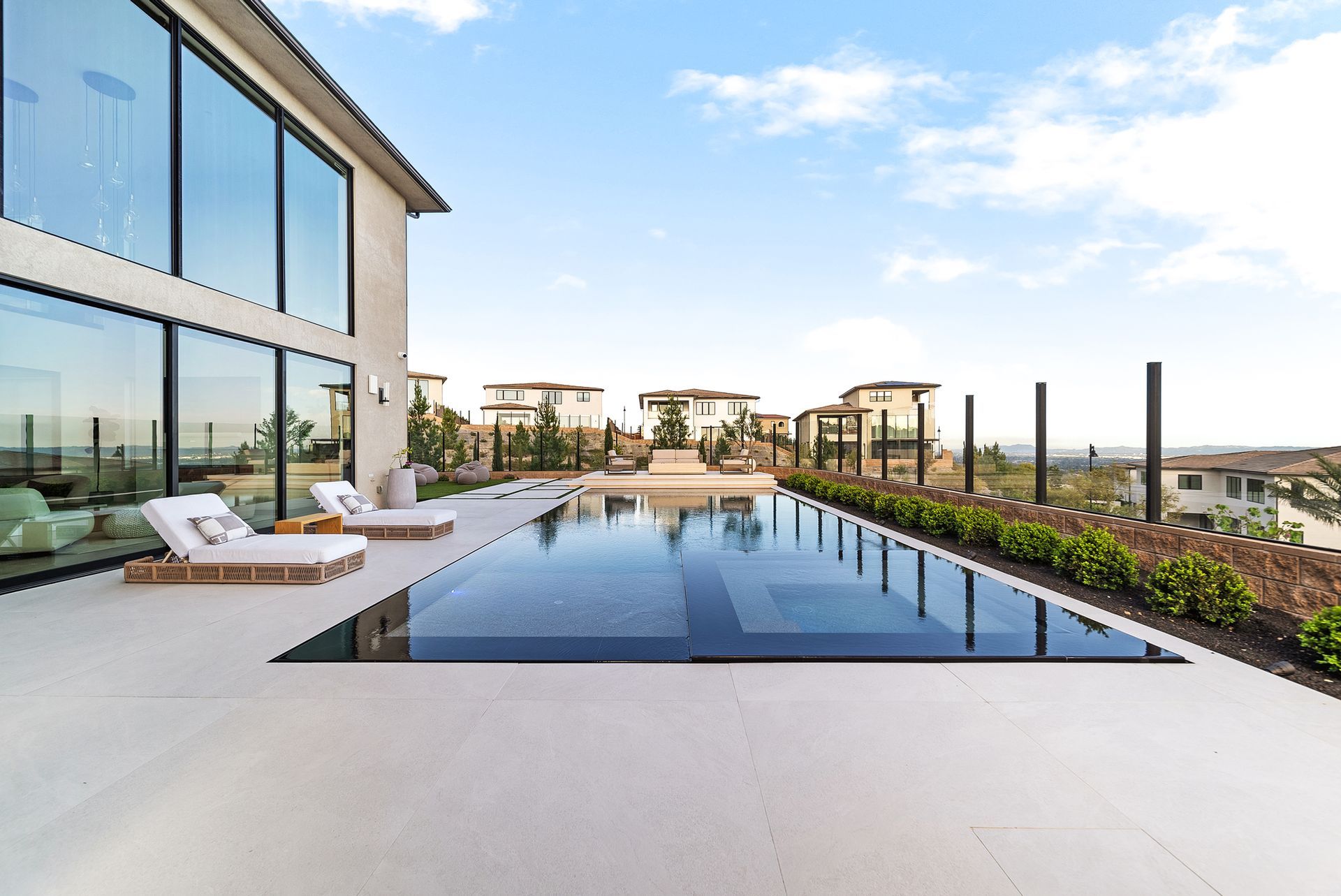 Luxury pool design and construction in Porter Ranch, Los Angeles. Design and build by Westmod. Day time photo of completed custom pool and outdoor living space.
