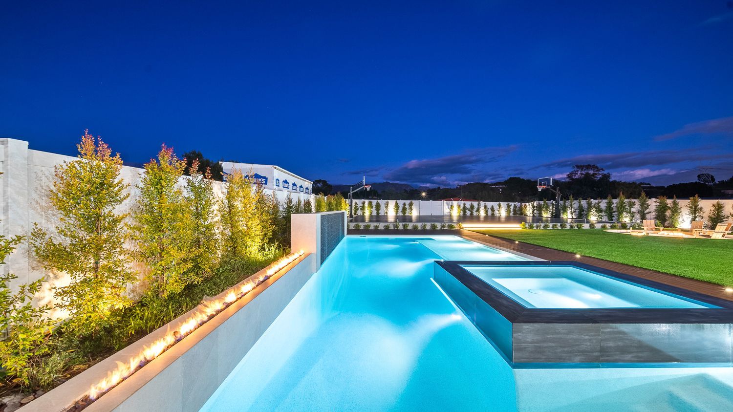 Custom pool and outdoor living project complete with a full court basketball court and outdoor kitchen. Project by Westmod. Location = Santa Clarita, CA.