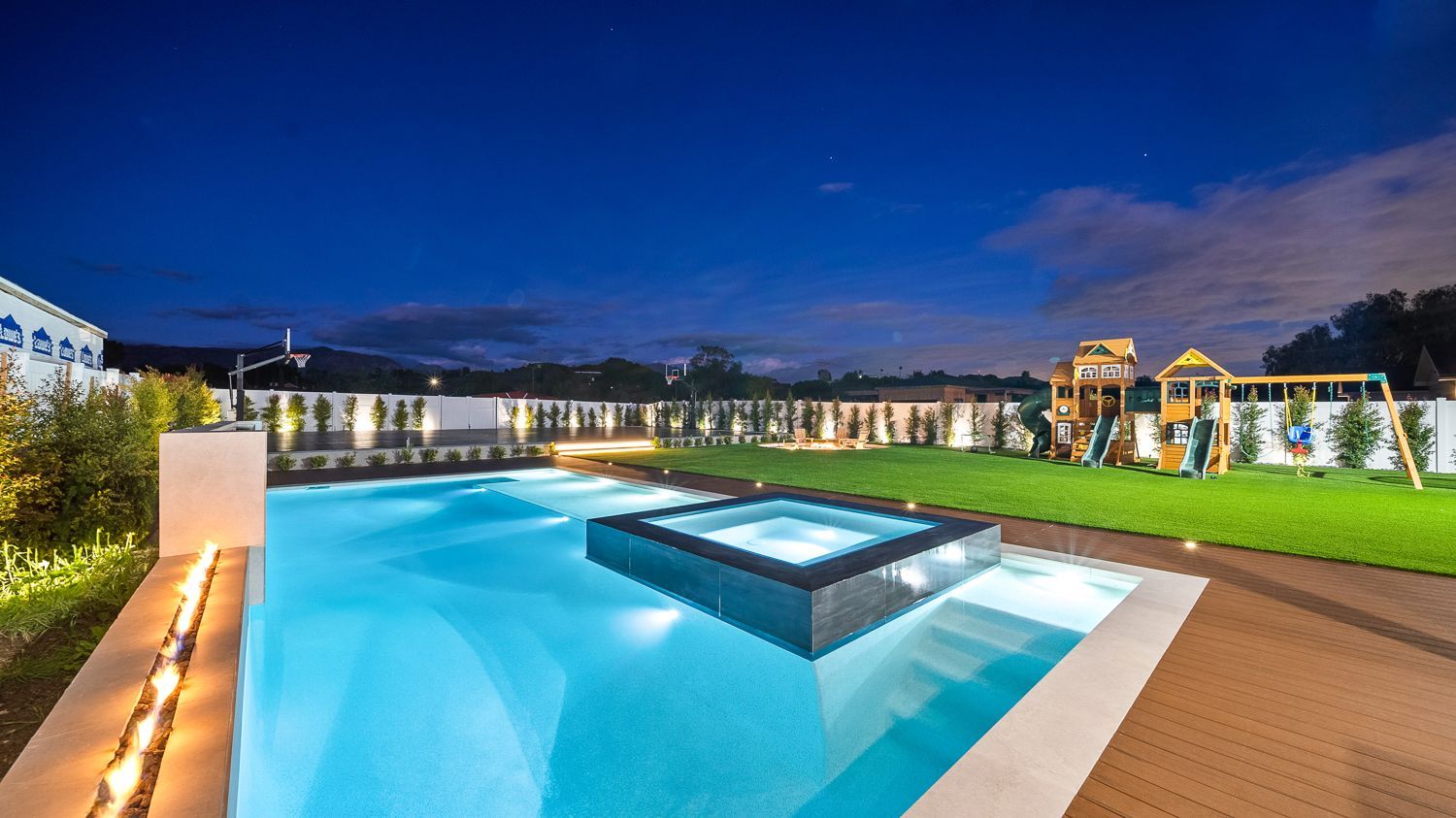 Custom pool and outdoor living project complete with a full court basketball court and outdoor kitchen. Project by Westmod. Location = Santa Clarita, CA.