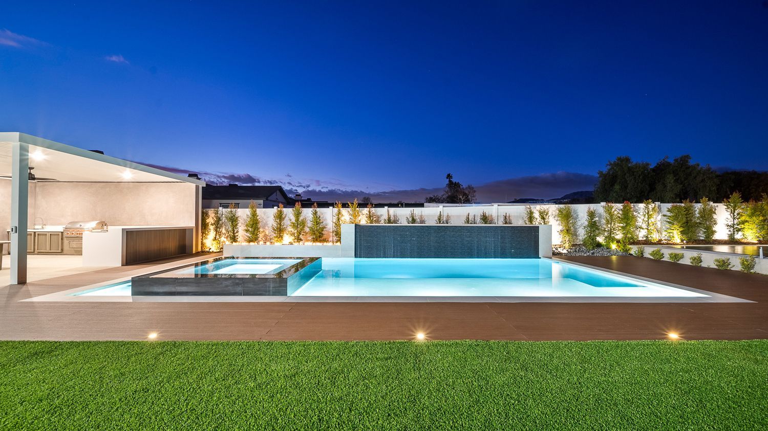 Custom pool and outdoor living project complete with a full court basketball court and outdoor kitchen. Project by Westmod. Location = Santa Clarita, CA.