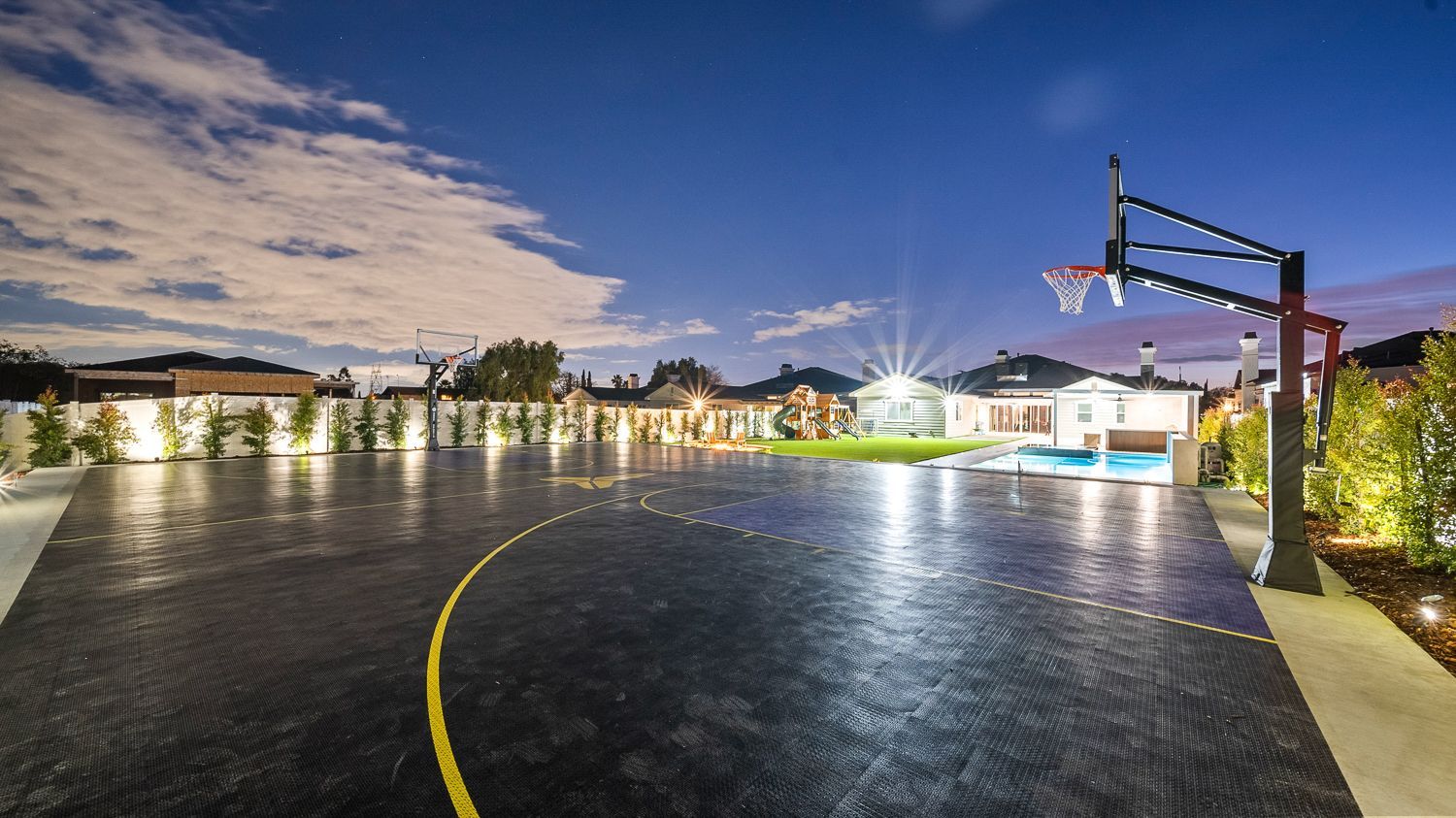 Custom pool and outdoor living project complete with a full court basketball court and outdoor kitchen. Project by Westmod. Location = Santa Clarita, CA.