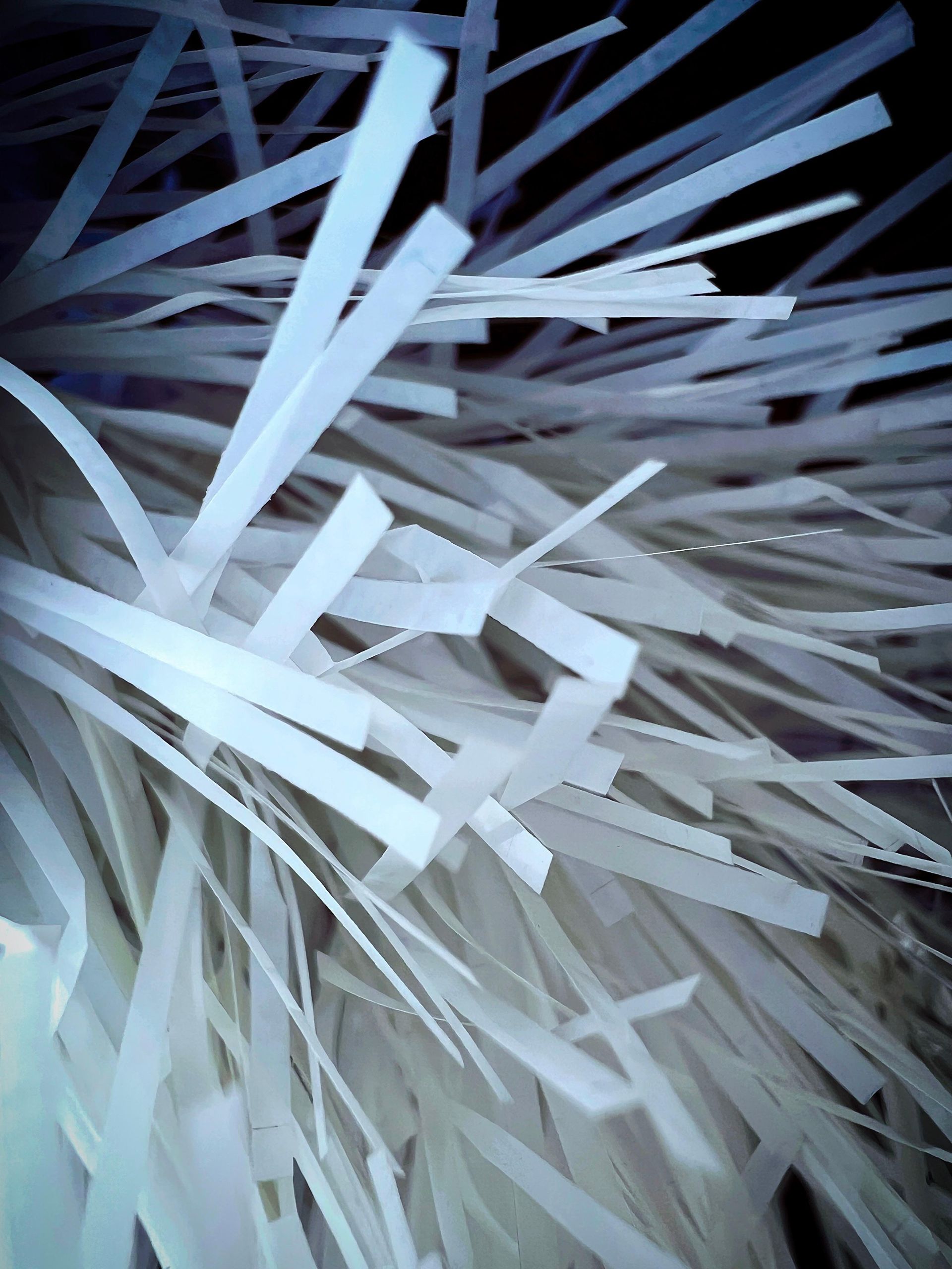 a pile of shredded paper with a black background