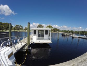 A boat is docked at a dock on a body of water.