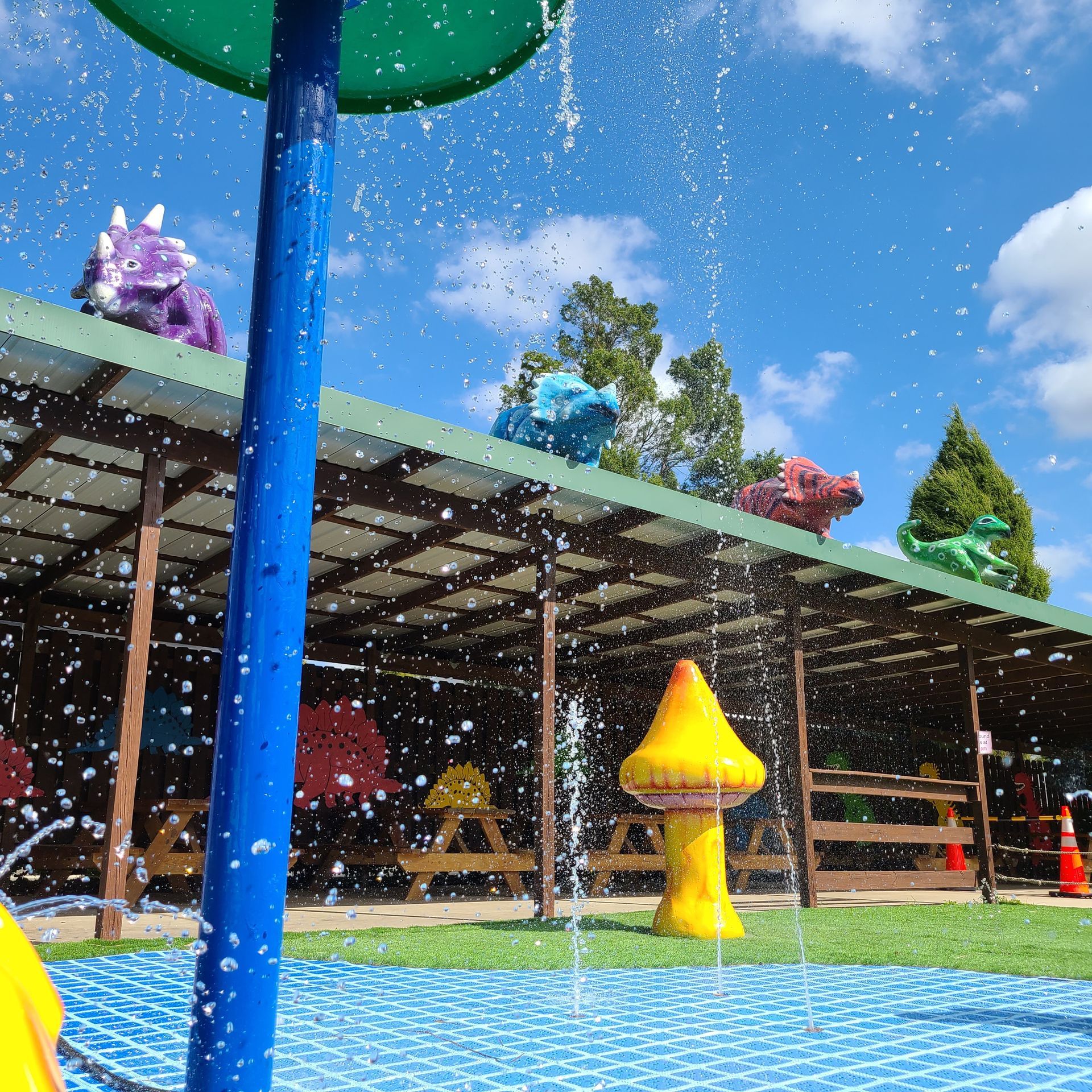 A water park with a blue pole in the foreground