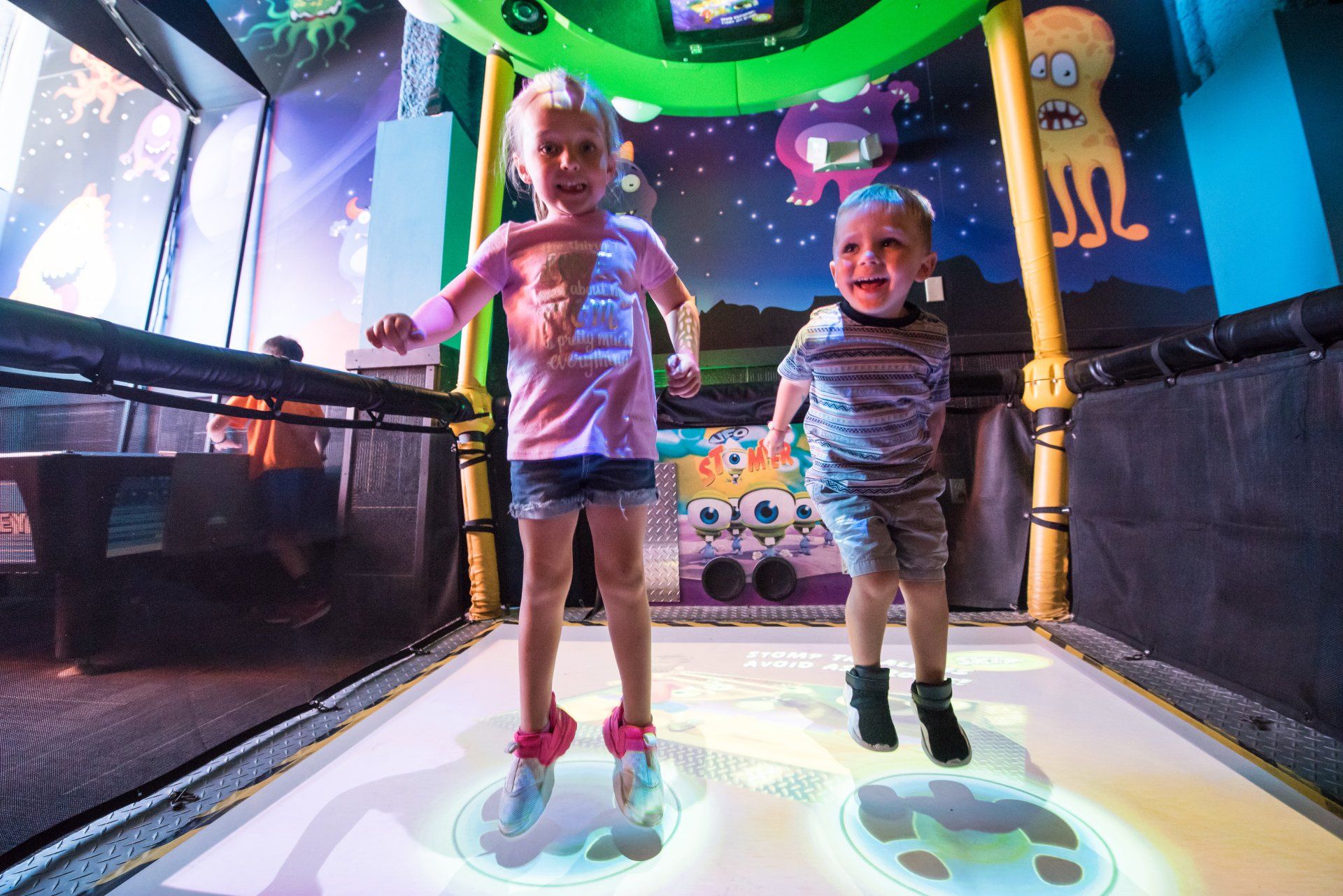 A boy and a girl are dancing on a dance floor.