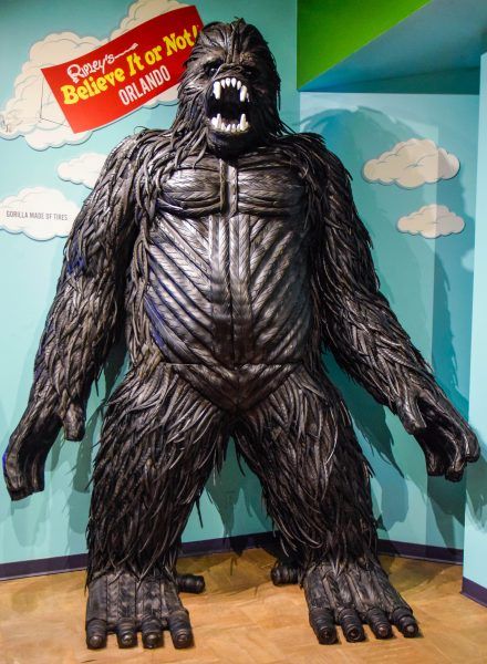 A statue of a gorilla with a sign that says believe it or not