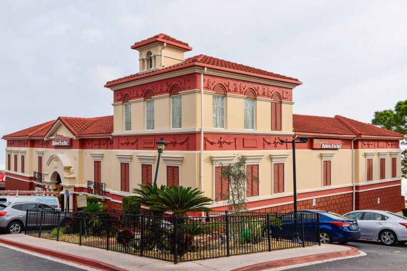 A large building with cars parked in front of it.