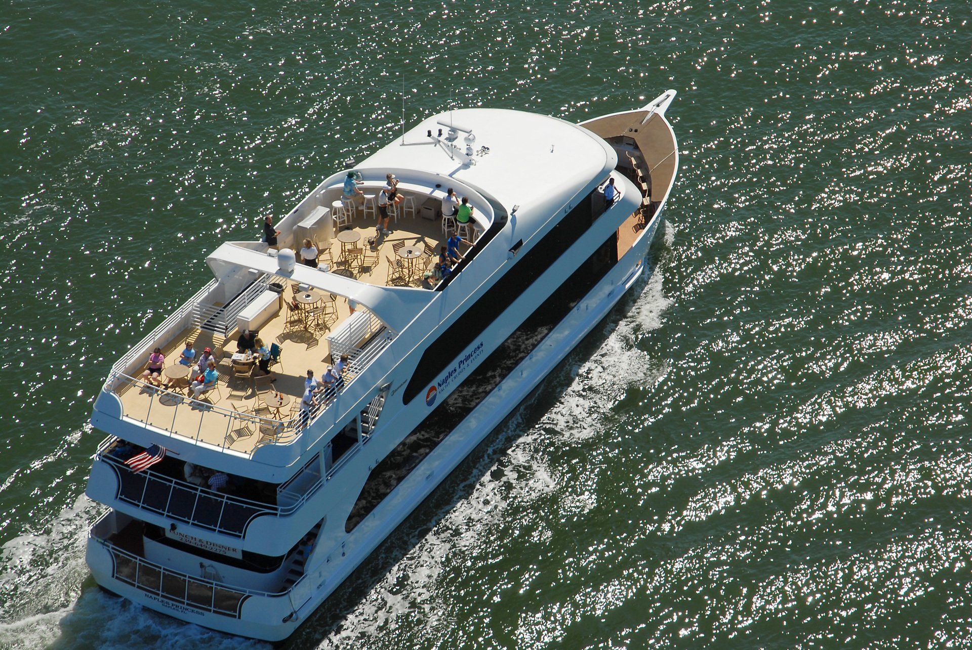 A large white boat is floating on top of a body of water