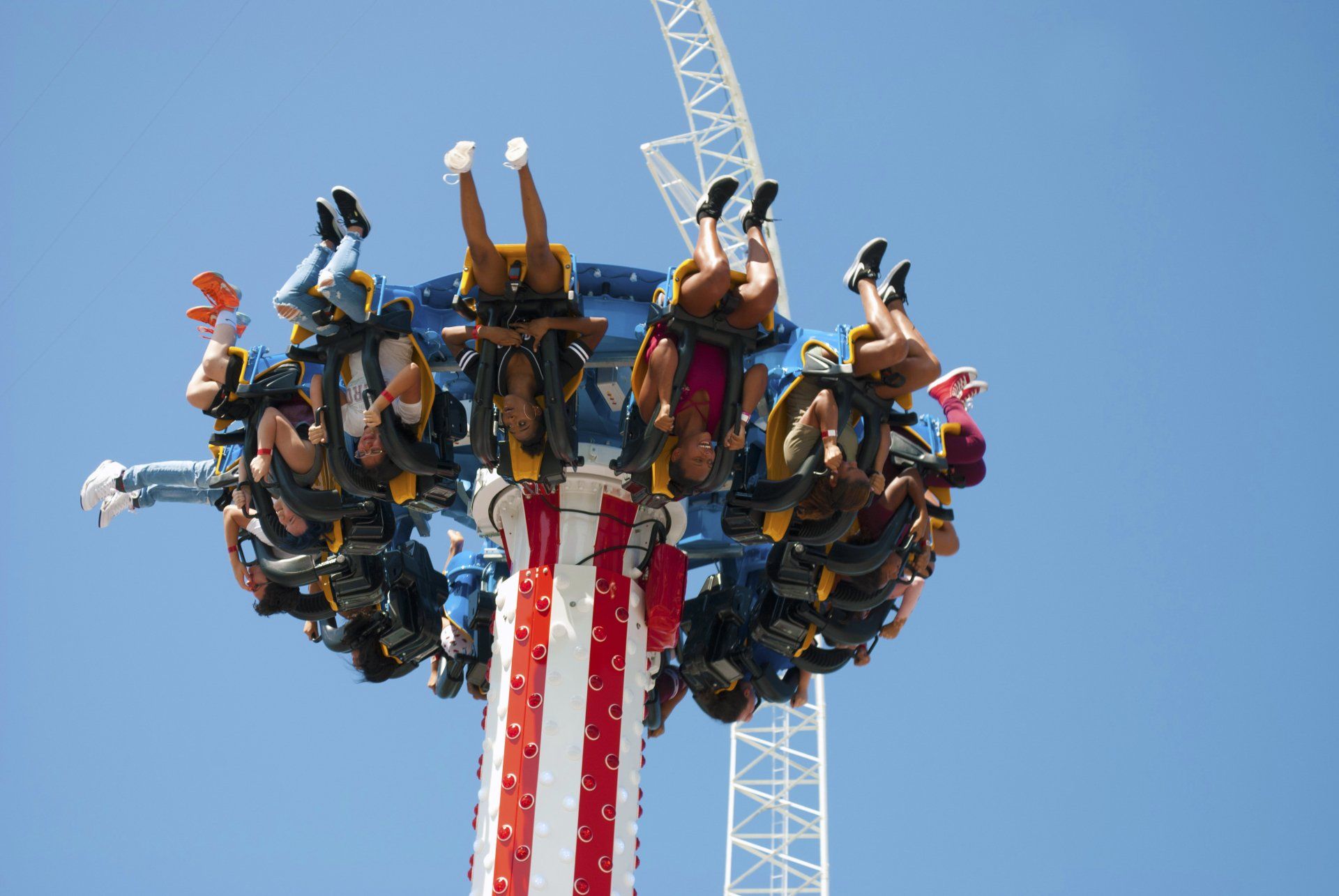 A group of people are riding a roller coaster at an amusement park.