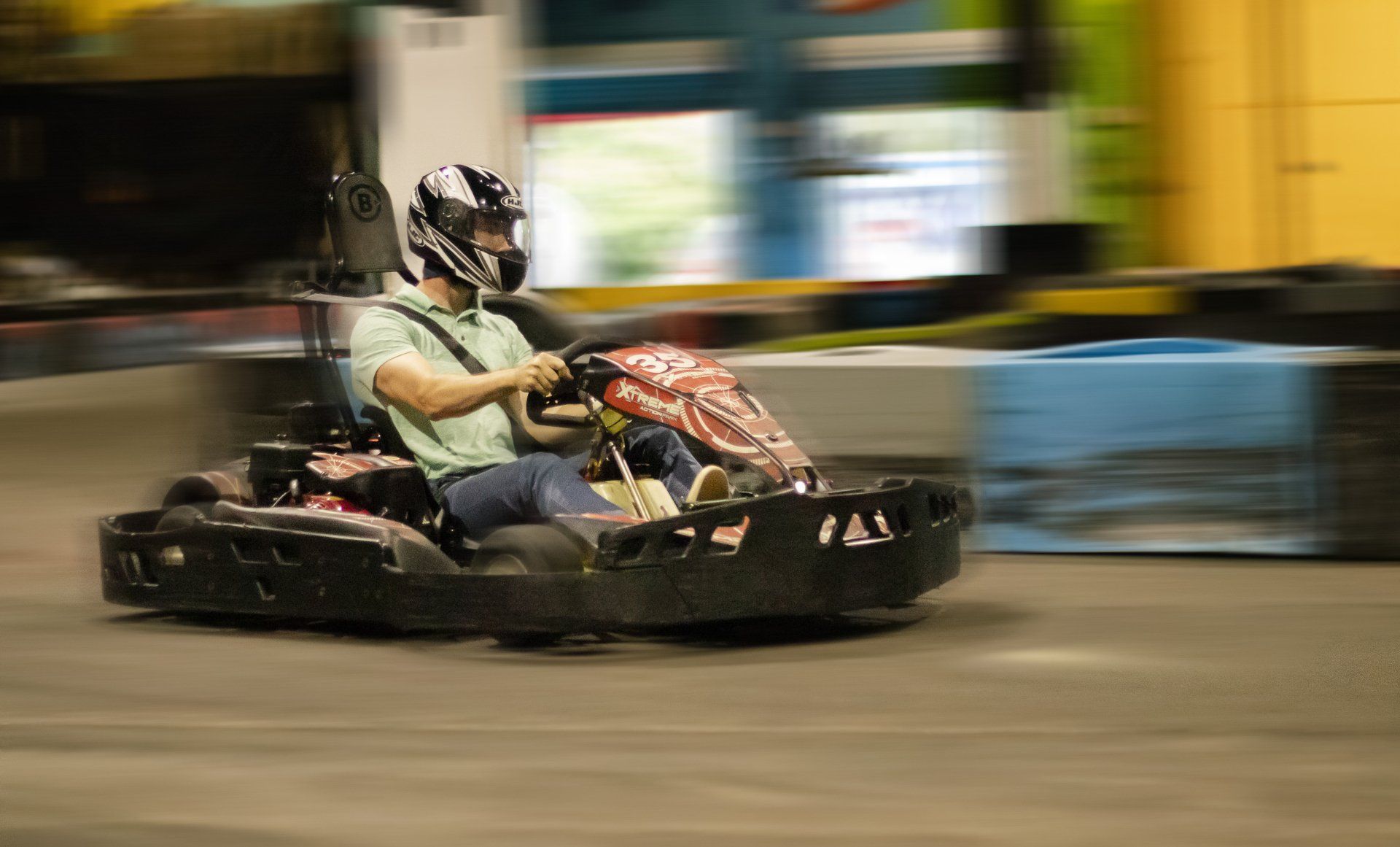 A man is riding a go kart on a track.