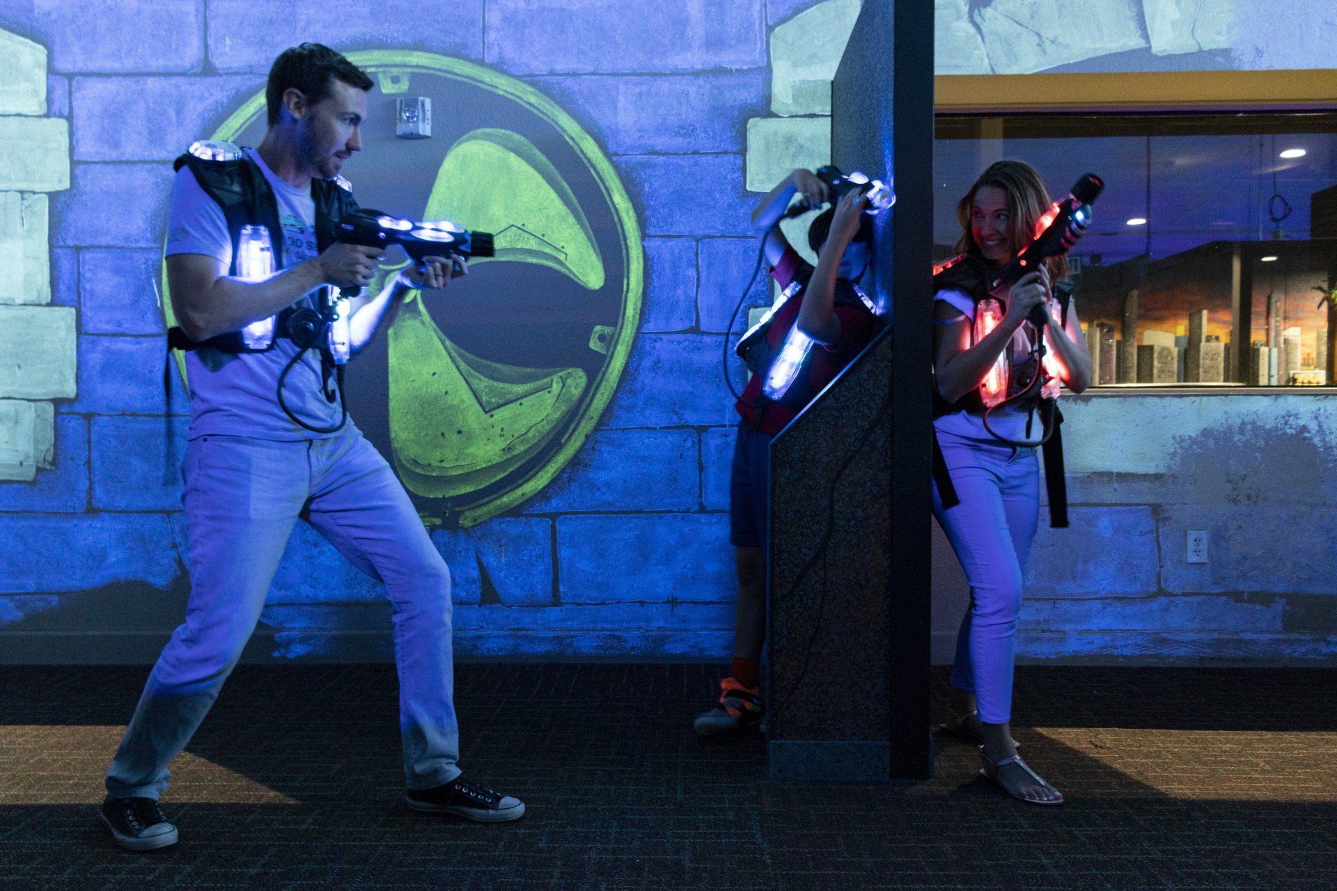 A man and a woman are playing a game of laser tag.