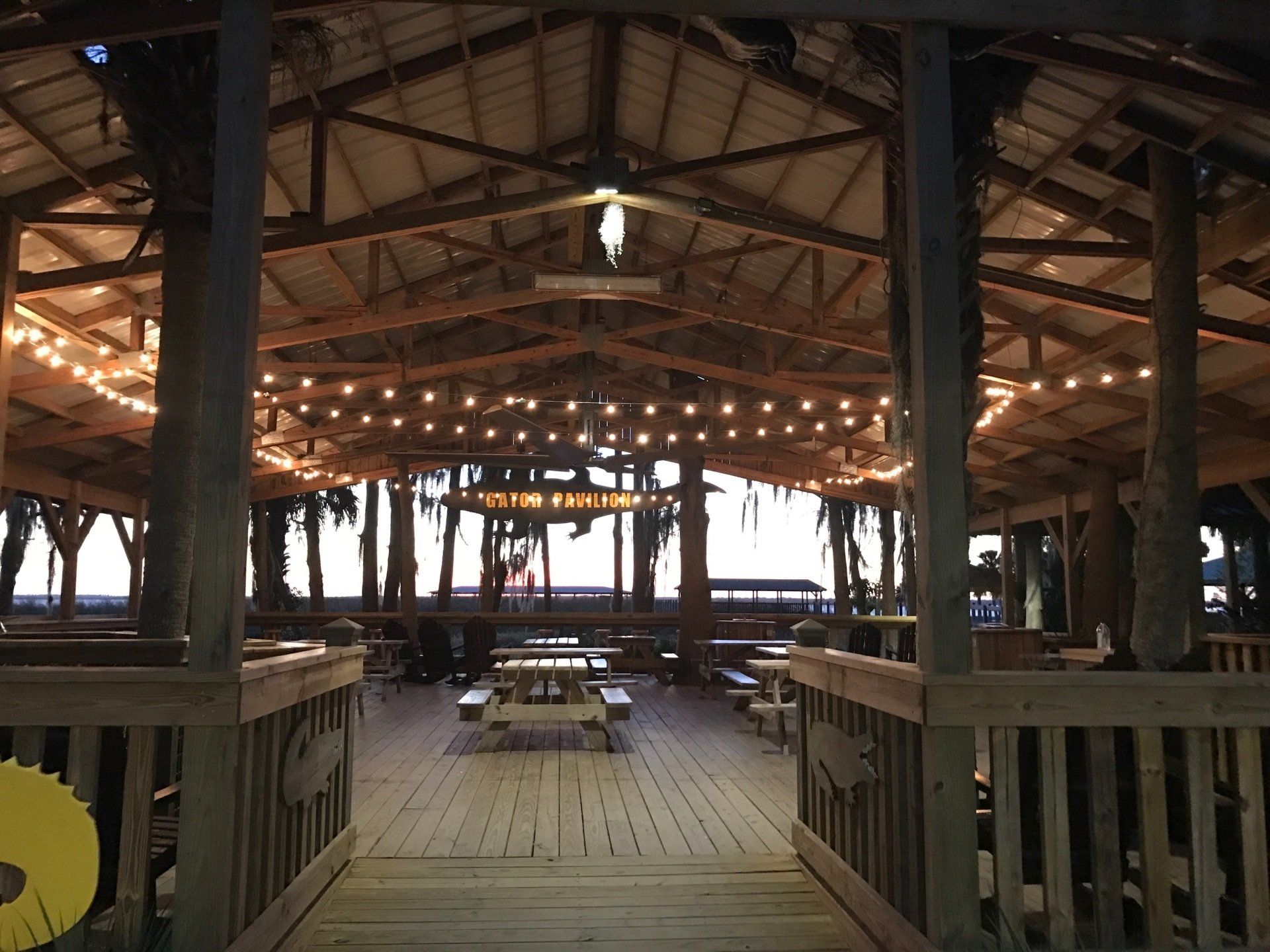 The inside of a building with tables and lights on the ceiling