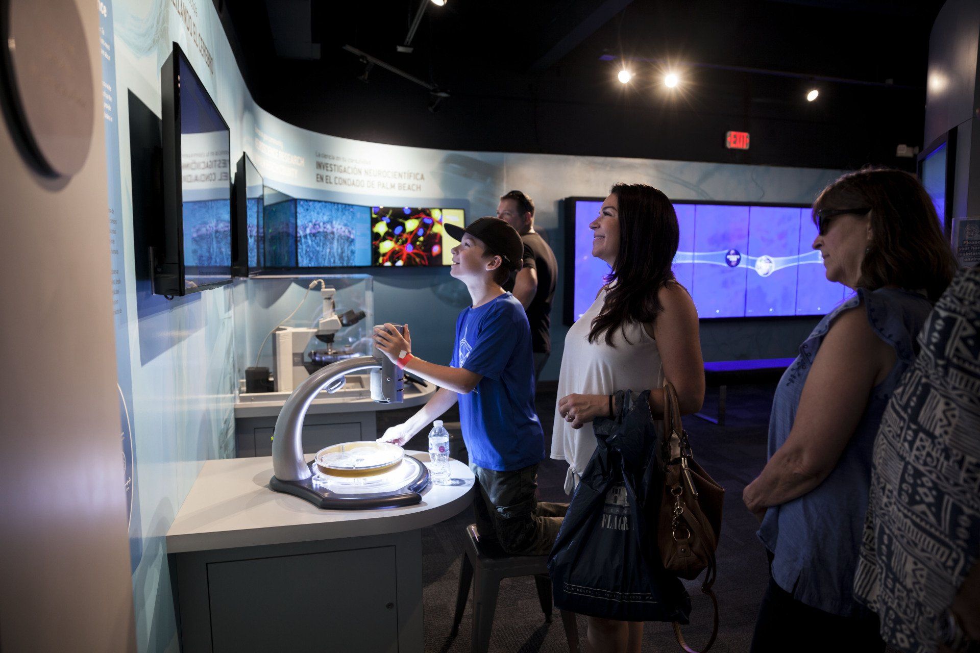 A group of people are looking at a display in a museum.