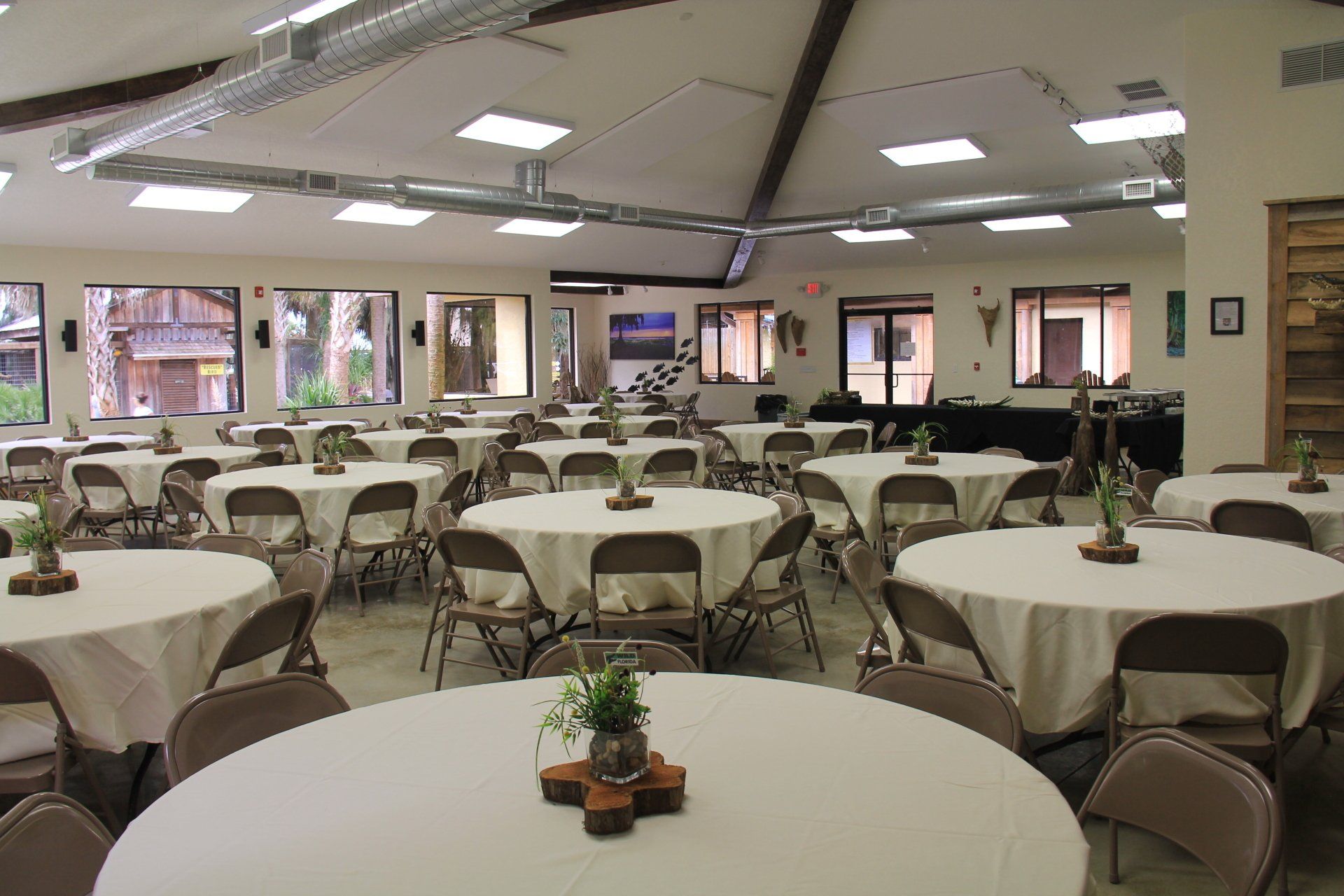 A large room with tables and chairs set up for a party