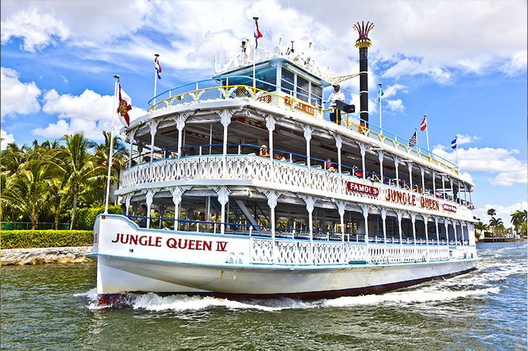 A large boat is floating on top of a body of water.