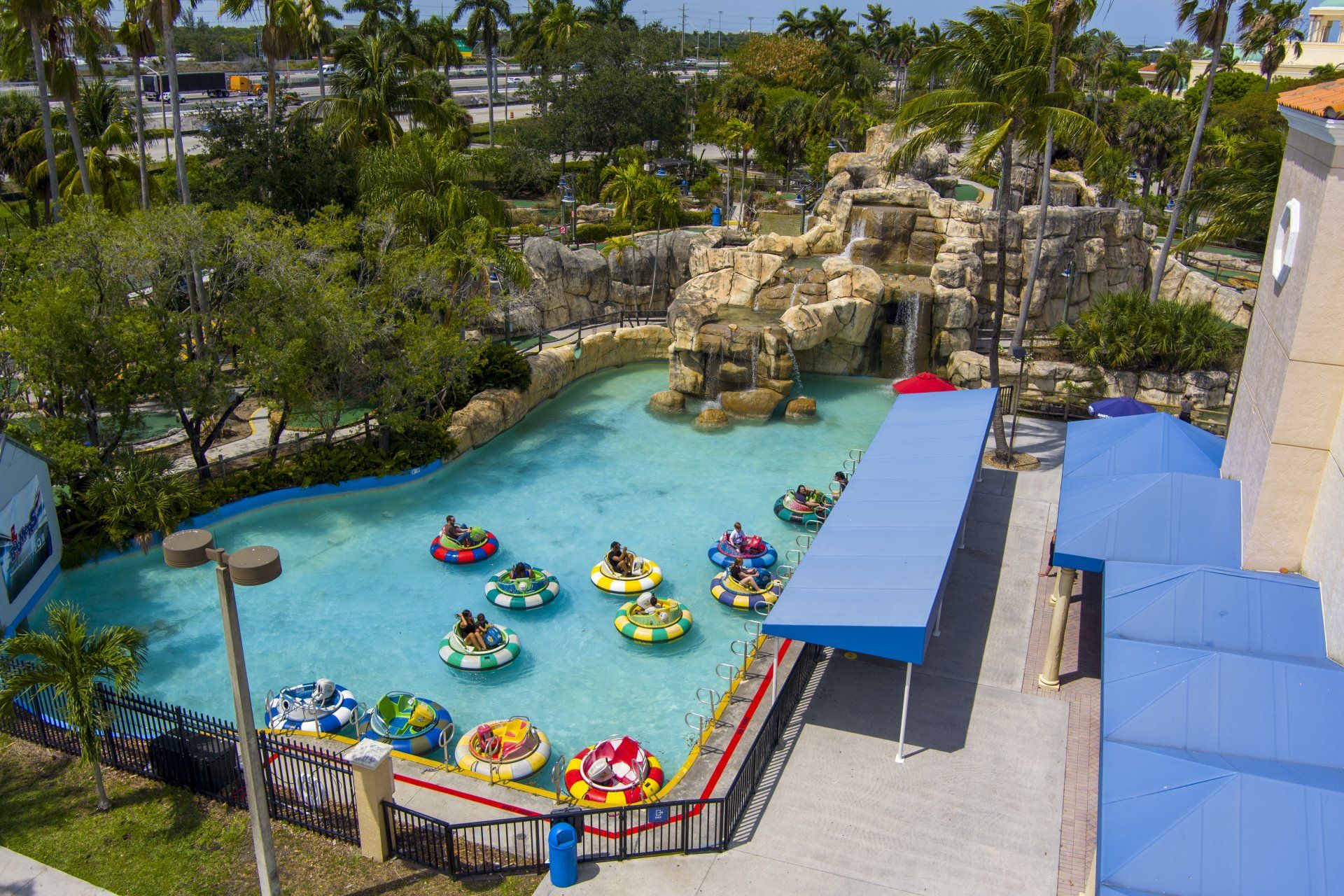 An aerial view of a water park with people riding rafts in the water.
