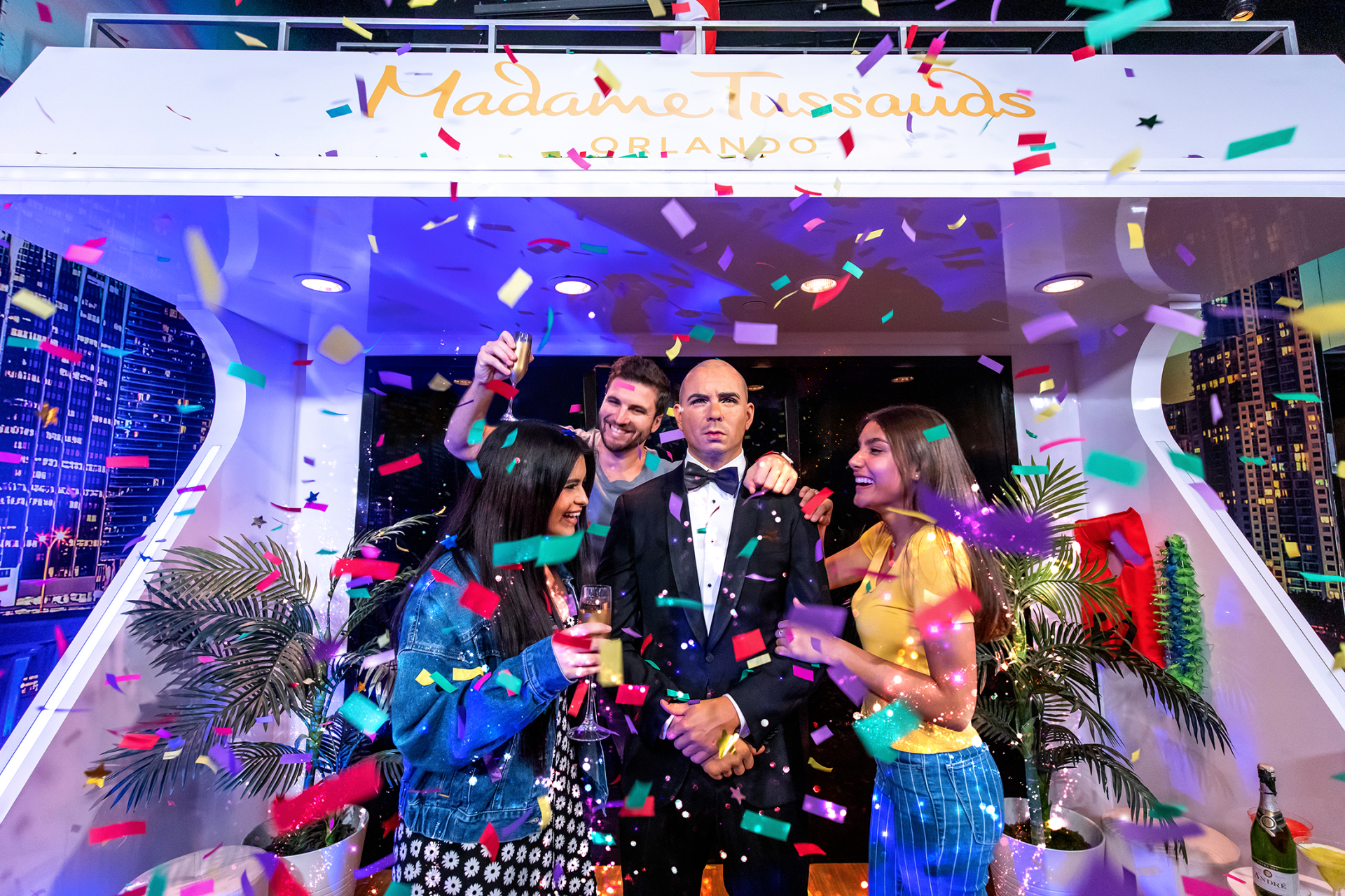A group of people are standing in front of a boat covered in confetti.