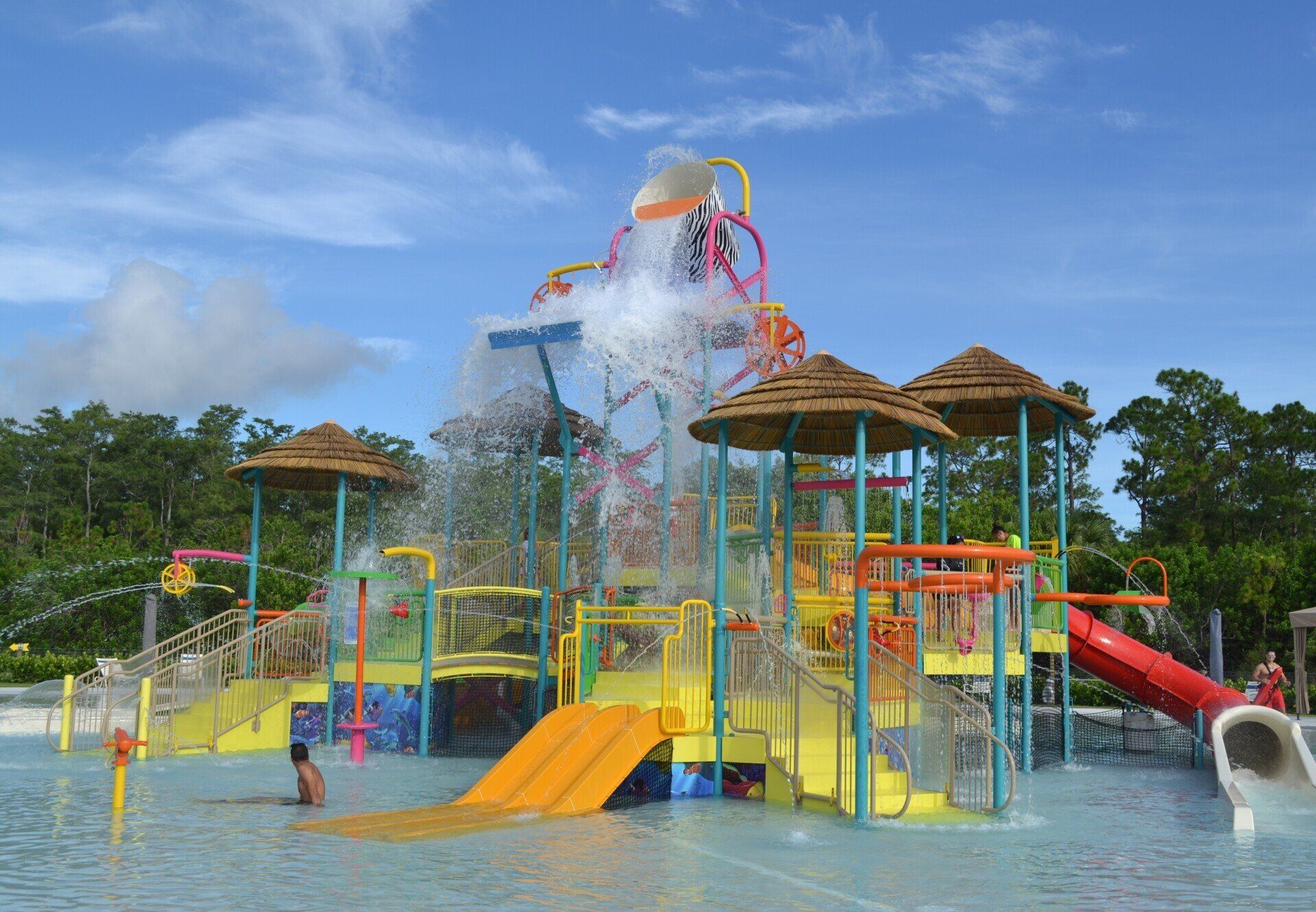 A water park with a slide and a waterfall