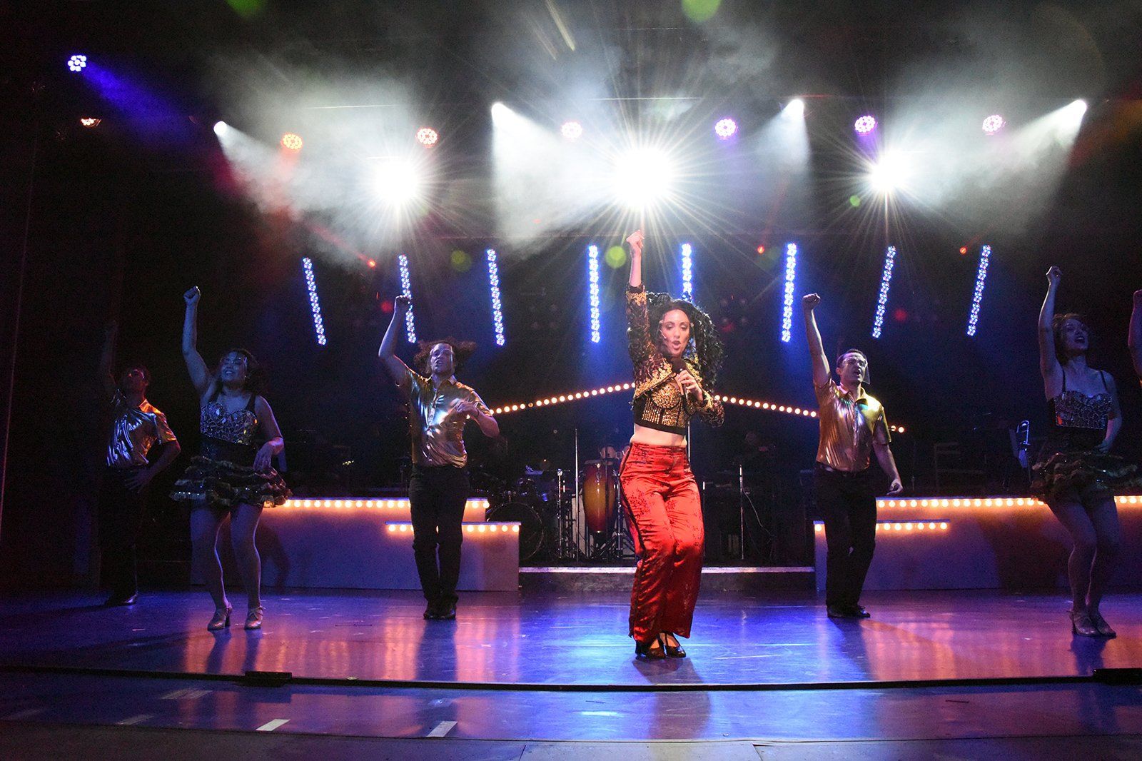 A group of people are dancing on a stage.