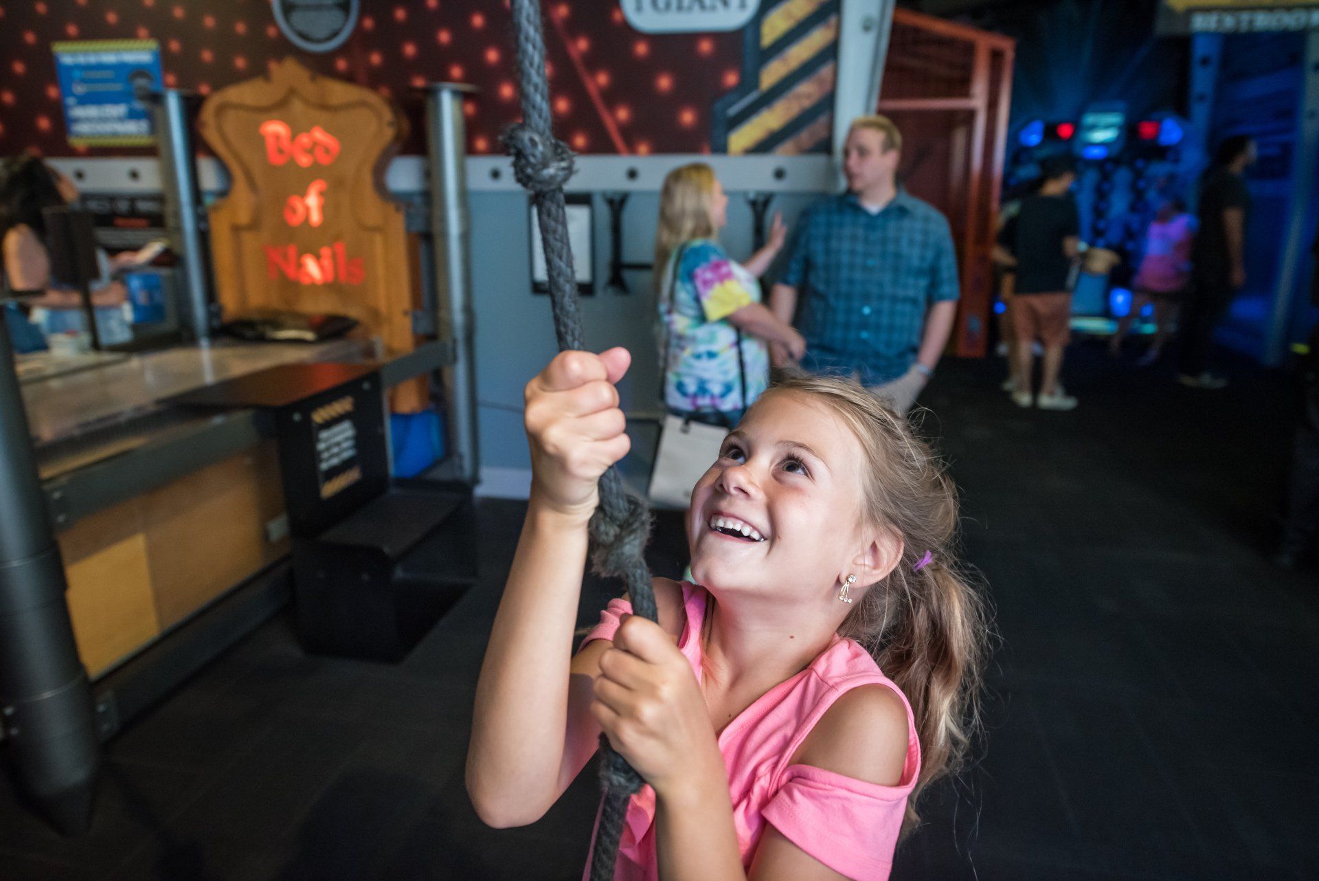 A little girl is holding a microphone in a museum.