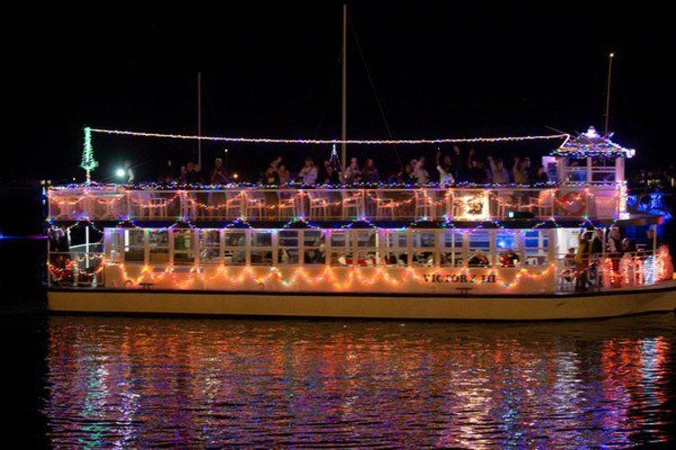 A large boat is floating on top of a body of water at night.