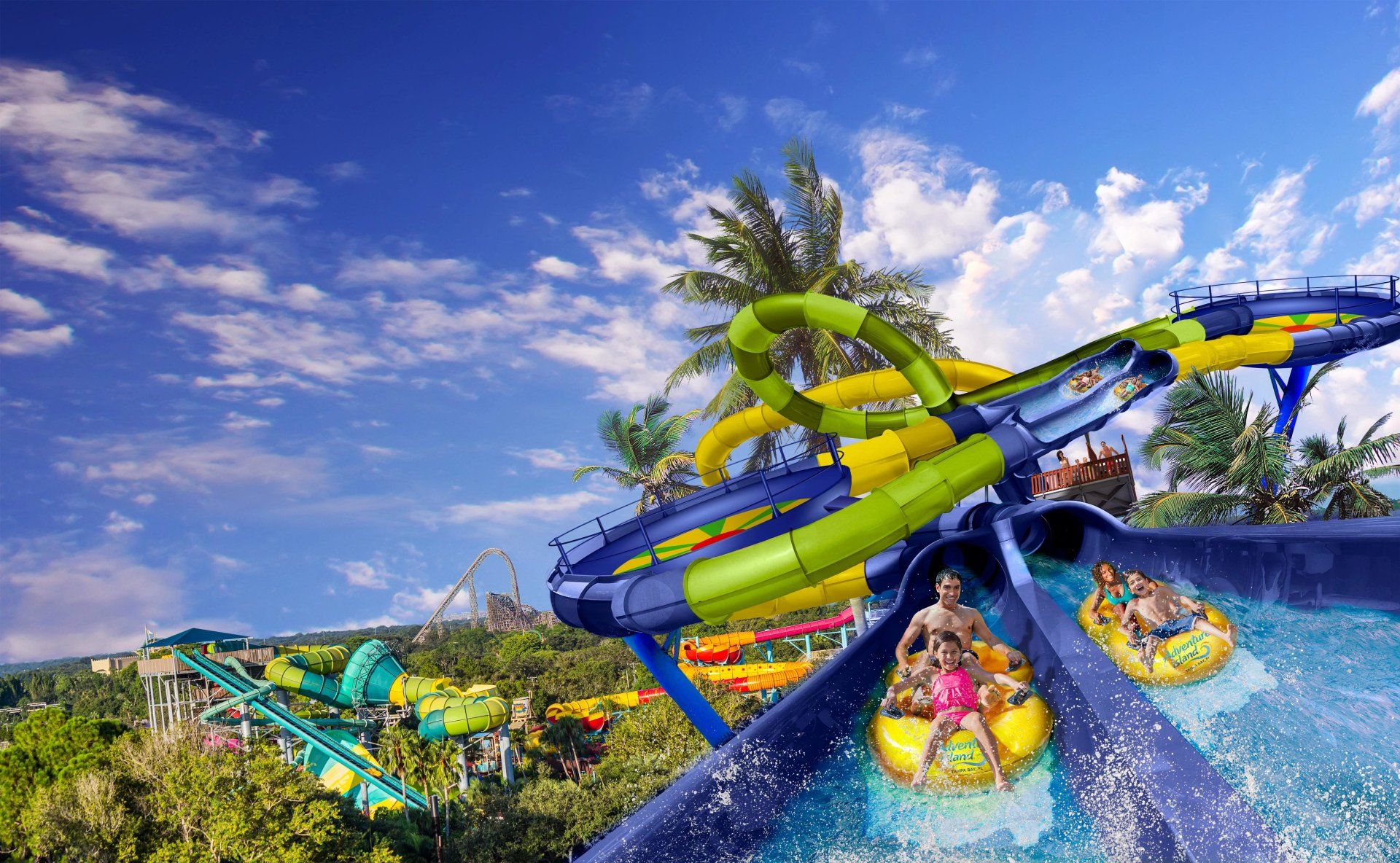 A group of people are riding down a water slide at a water park.