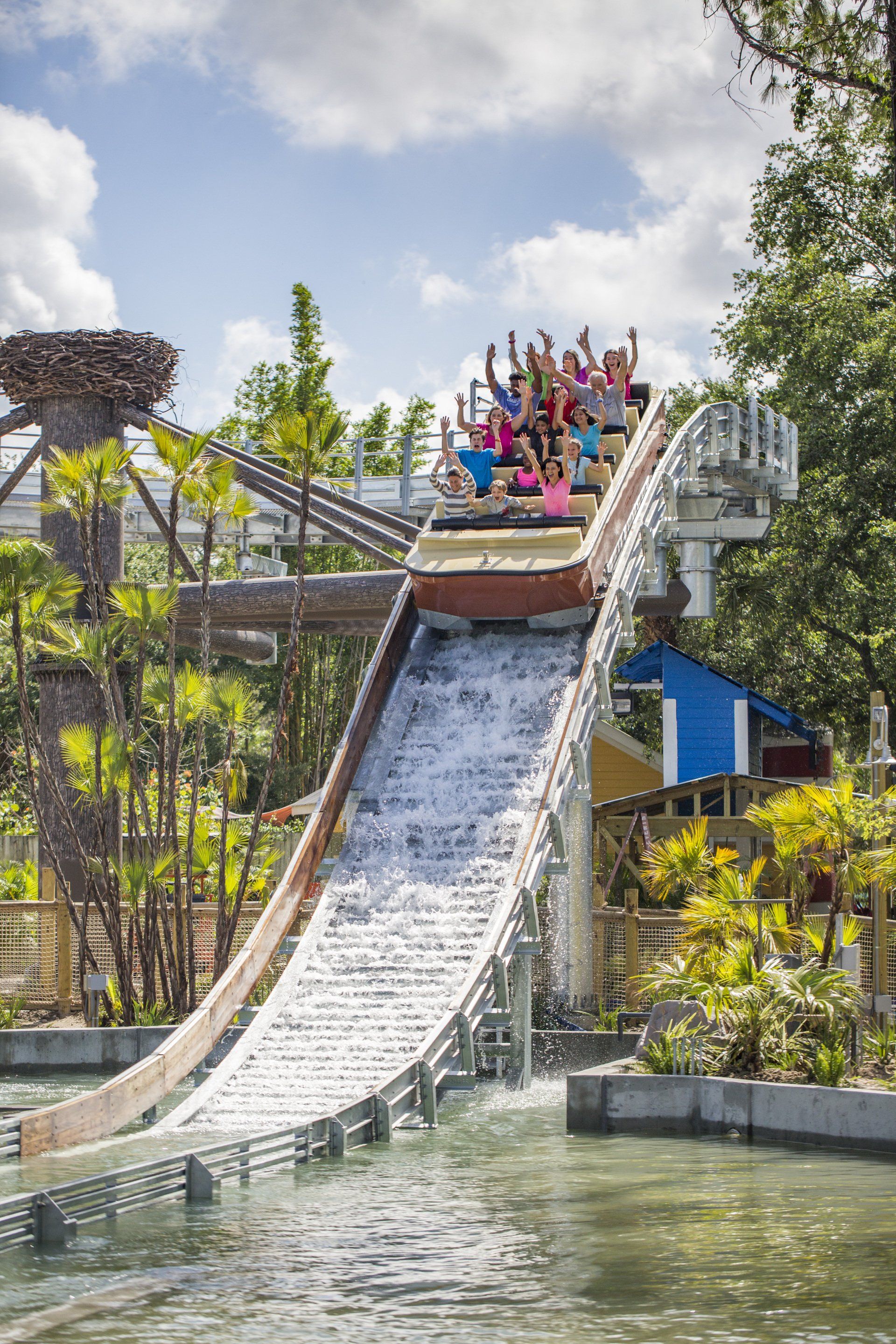 A group of people are riding a roller coaster down a water slide.