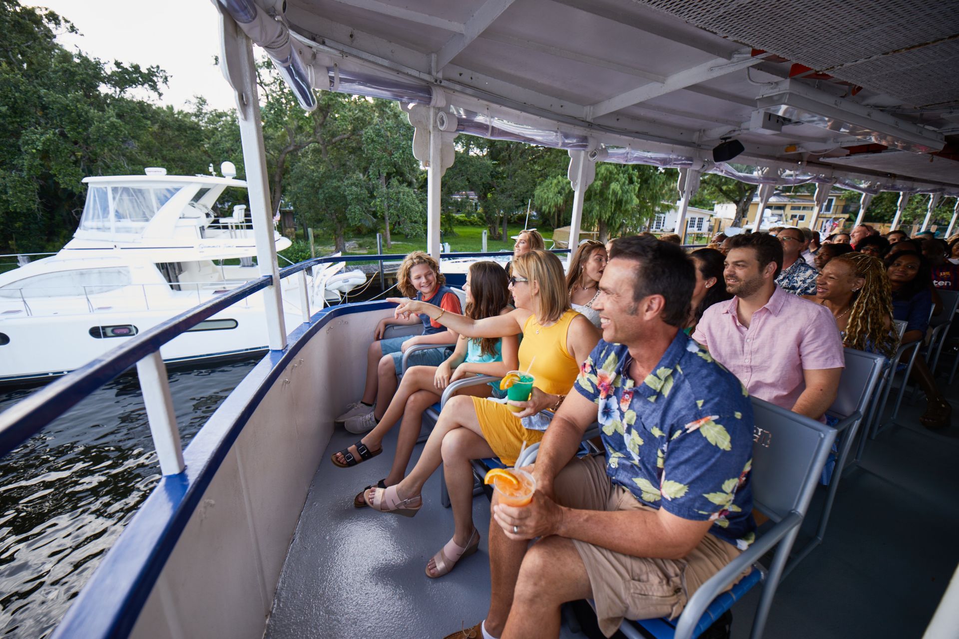A group of people are sitting on the deck of a boat.