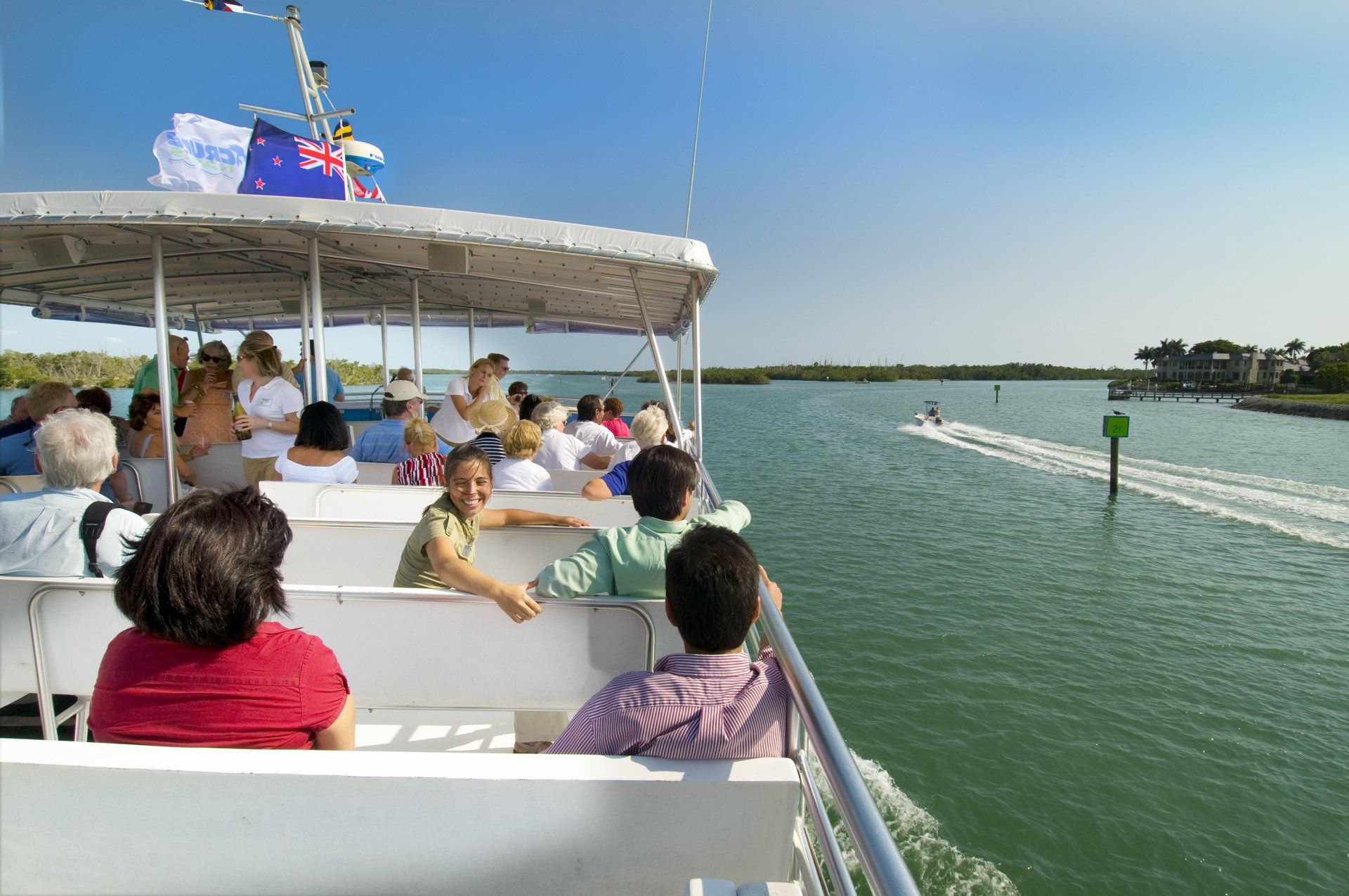 A group of people are sitting on a boat in the water.