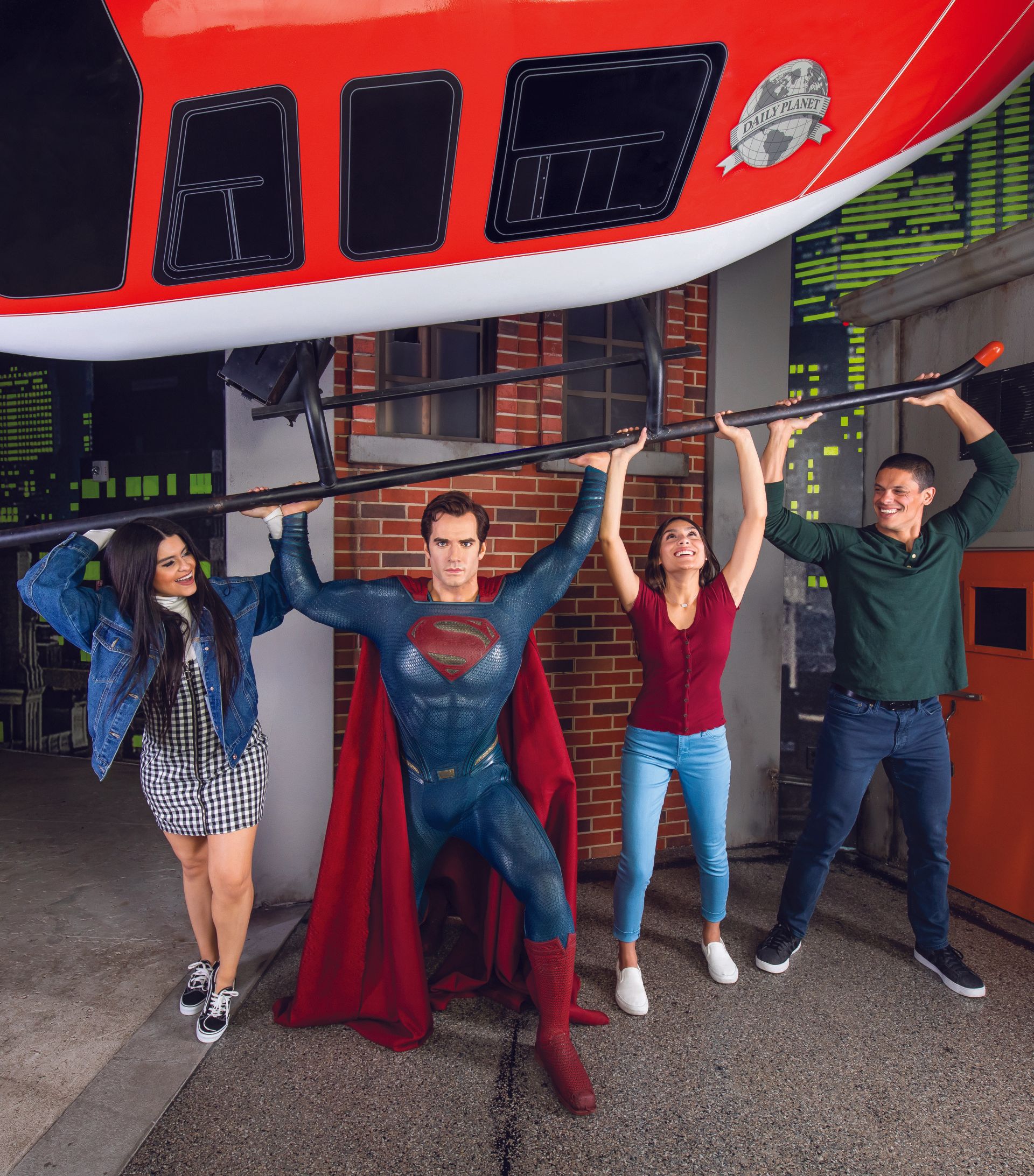 A group of people are posing for a picture with superman