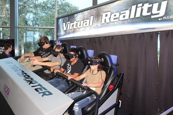 A group of people are riding a virtual reality roller coaster.