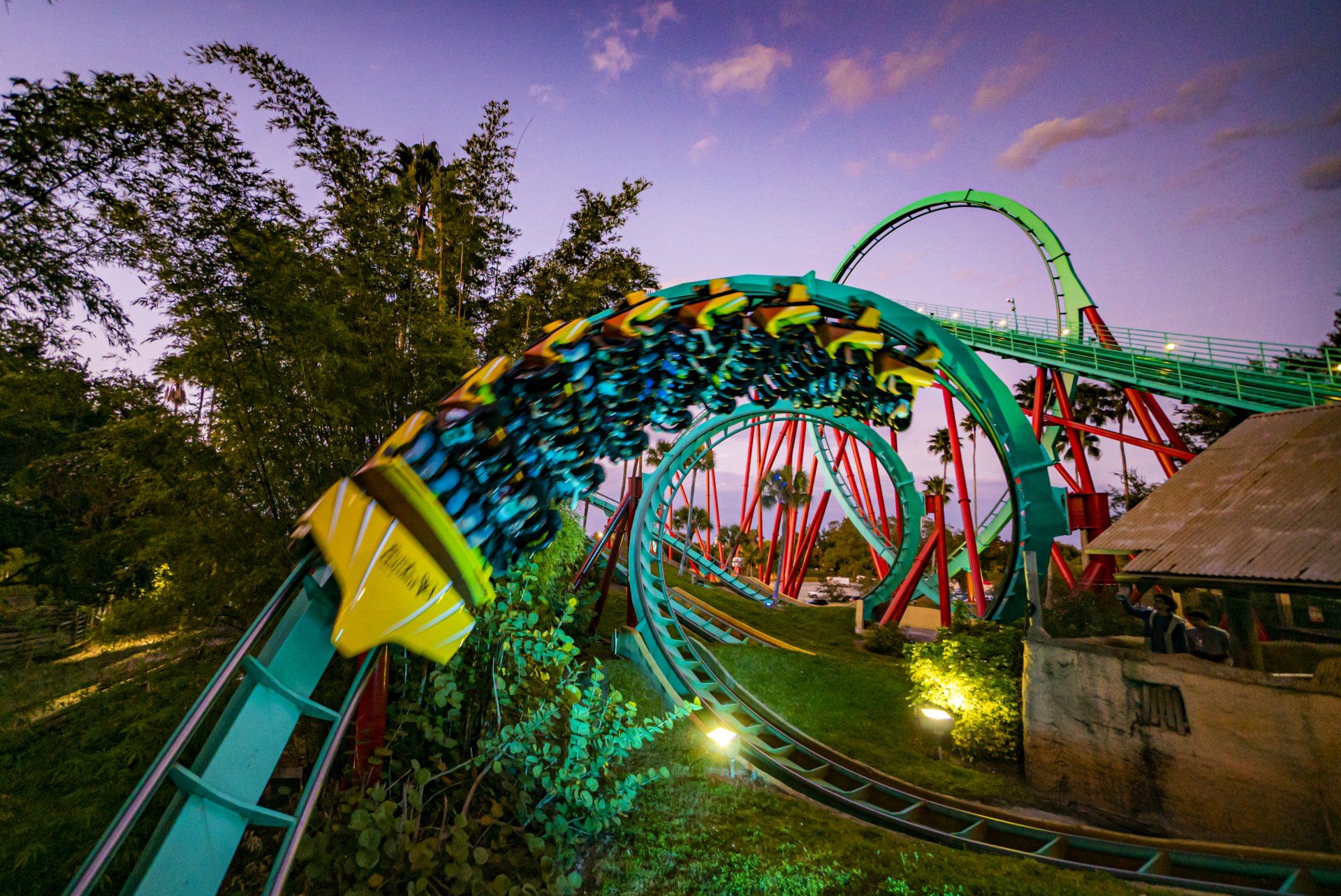 A roller coaster is going through a loop at an amusement park.