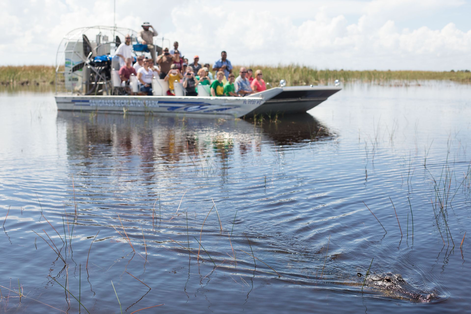 A group of people are riding on a boat in the water.