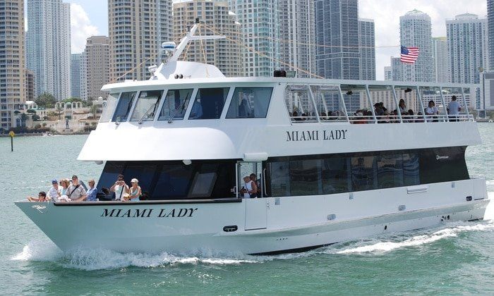 A white boat named miami lady is floating on the water