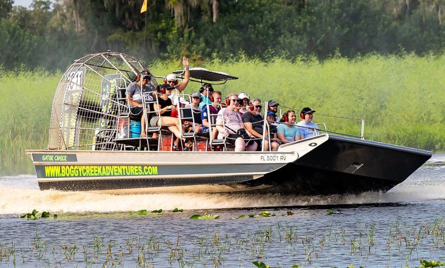 A group of people are riding on a boat in the water.