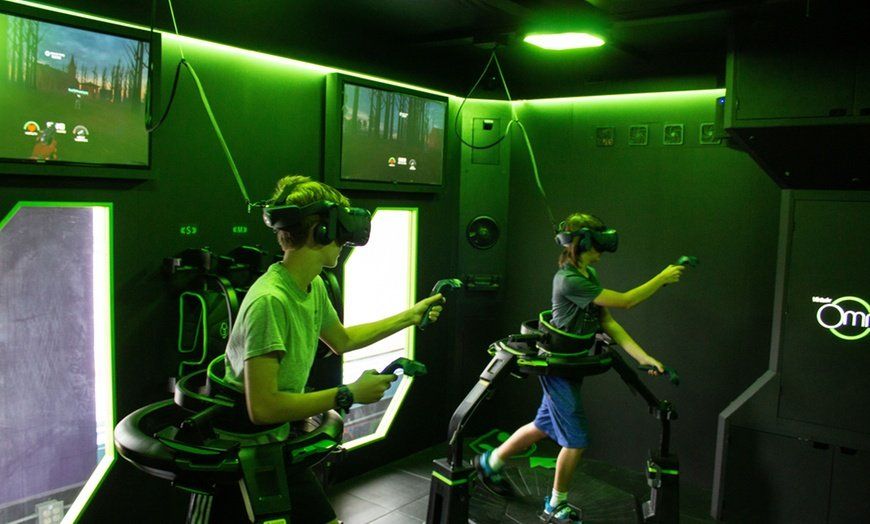 Two children are playing a virtual reality game in a room.