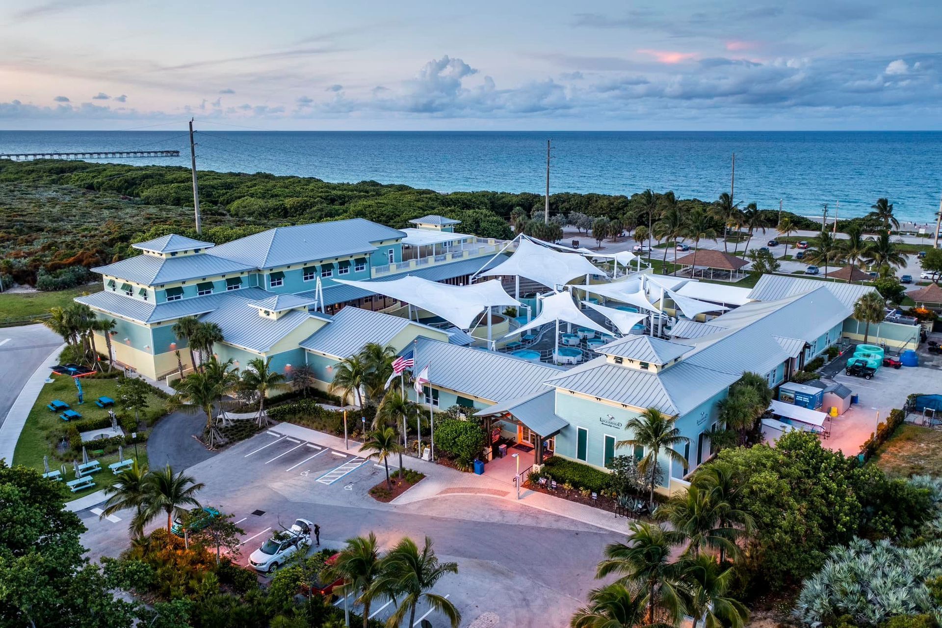 An aerial view of a large building next to the ocean.