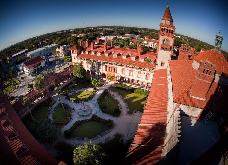 An aerial view of a large red building with a clock tower