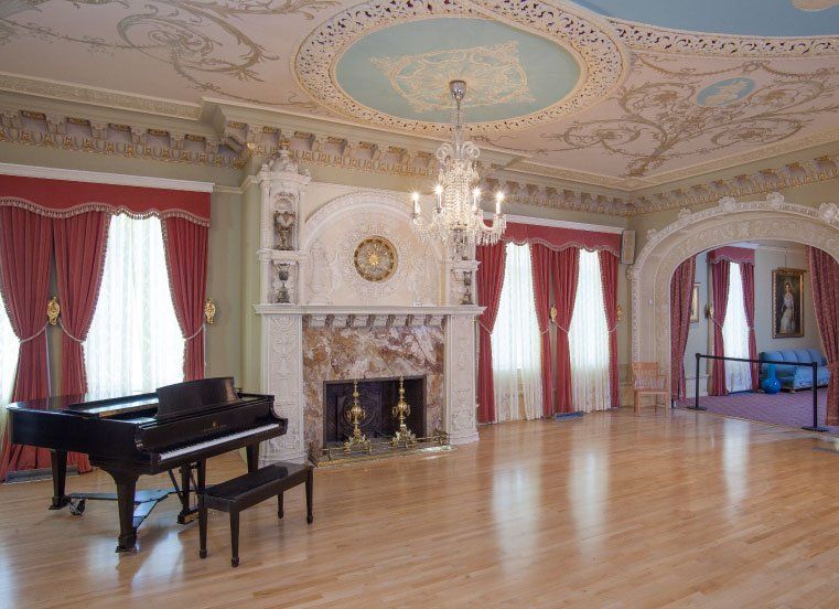 A large room with a piano and a fireplace