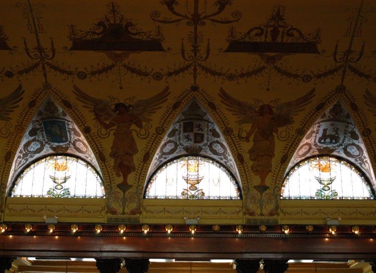 A ceiling with arched windows and candles on it