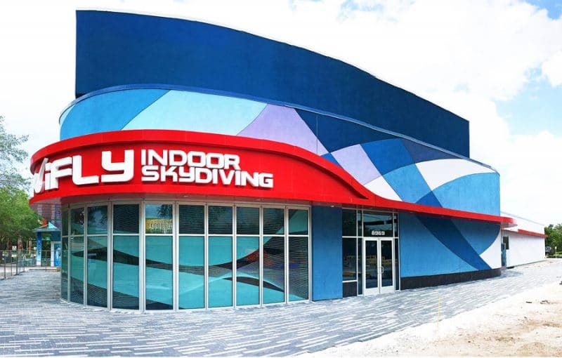 A blue and red building that says fly indoor skydiving