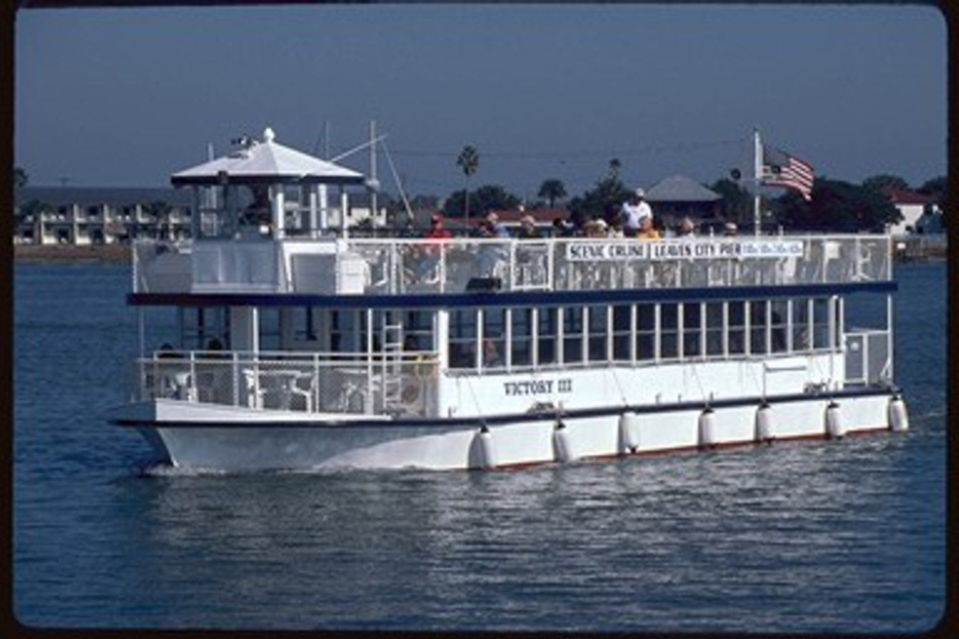A large white boat is floating on top of a body of water.