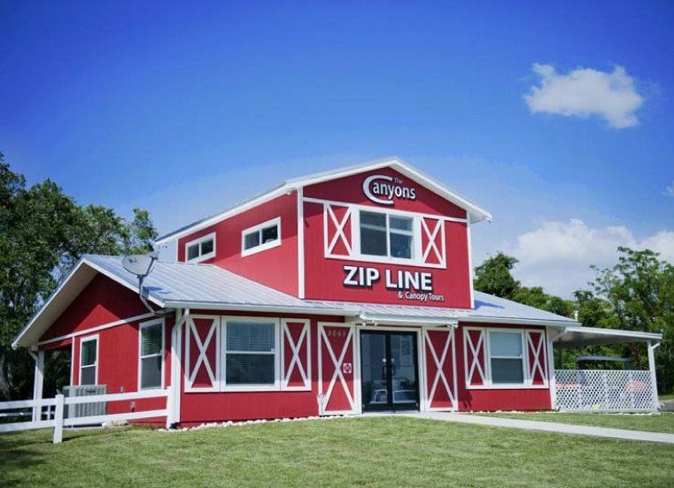 A red building with the word zip line on it