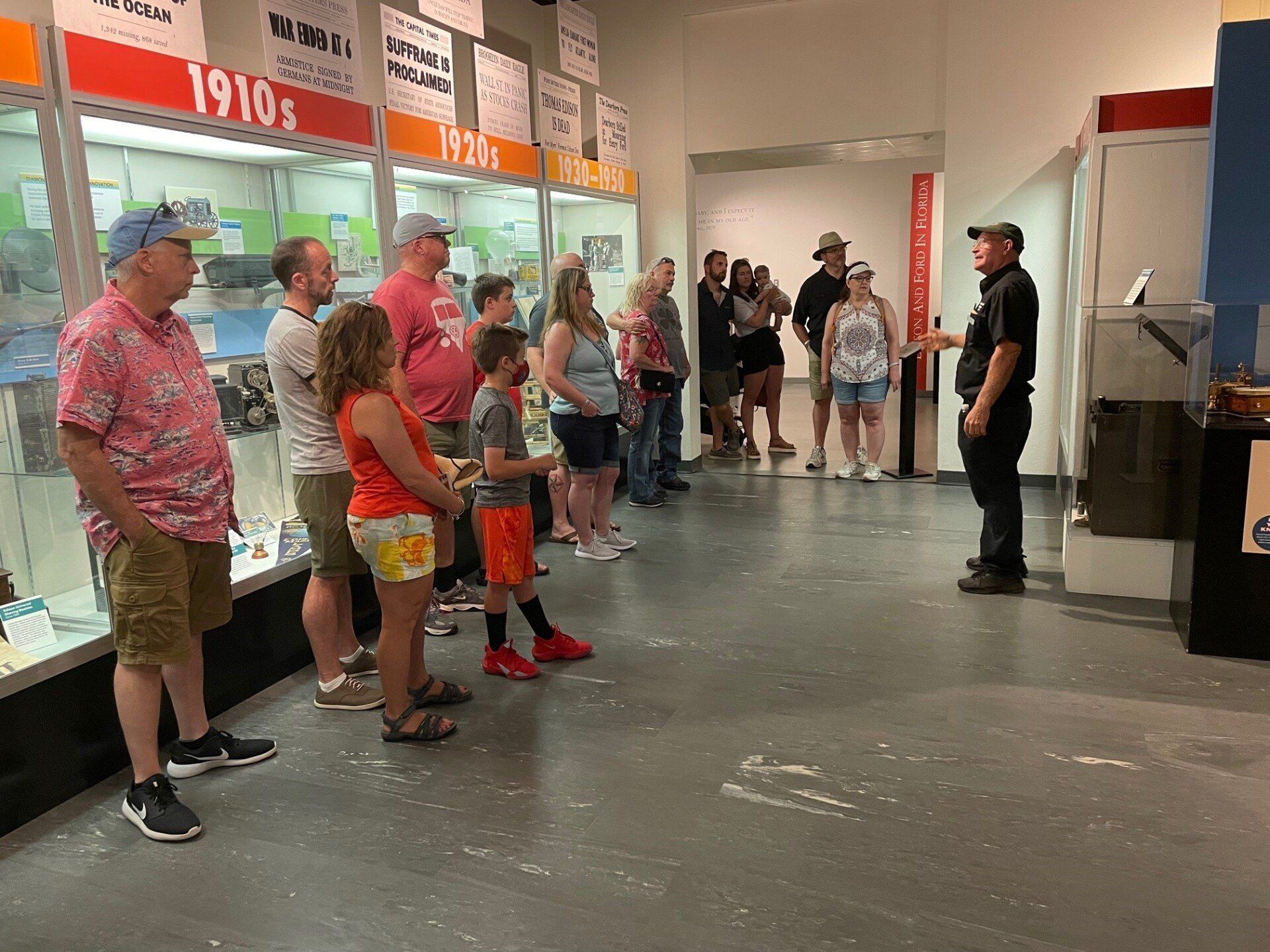 A group of people are standing in a museum.