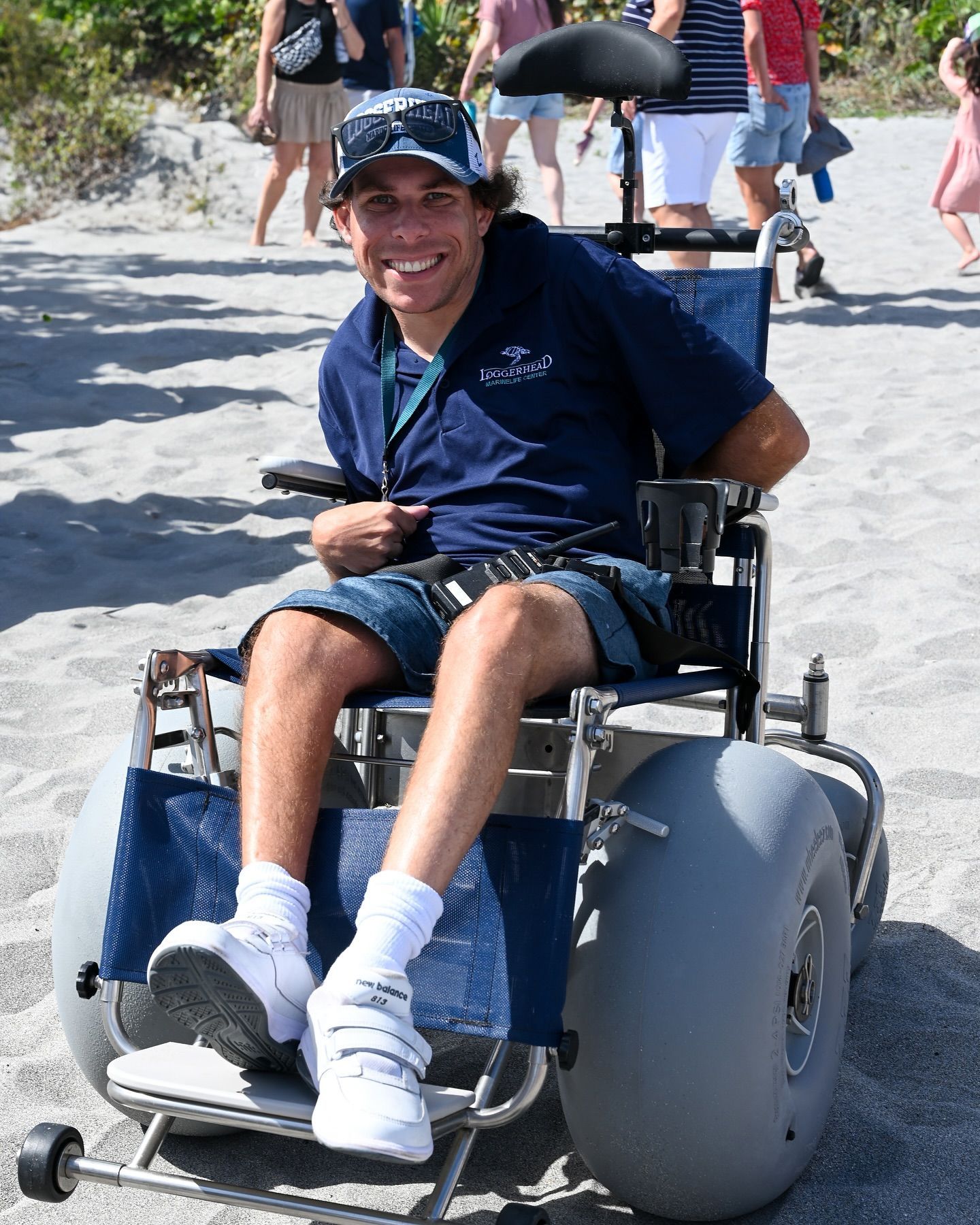A man in a wheelchair is wearing a polo shirt