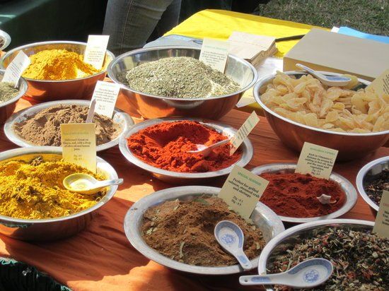 A table full of bowls of spices and spoons