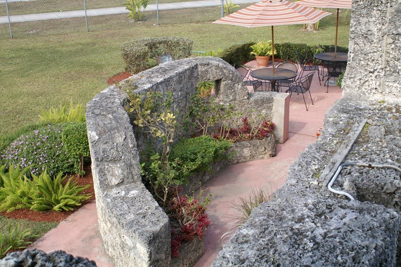 A patio area with tables and chairs and umbrellas