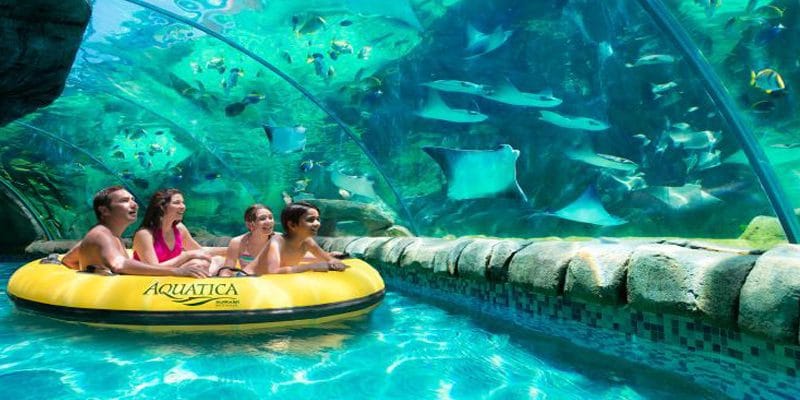 A group of people are riding a raft in a water park.